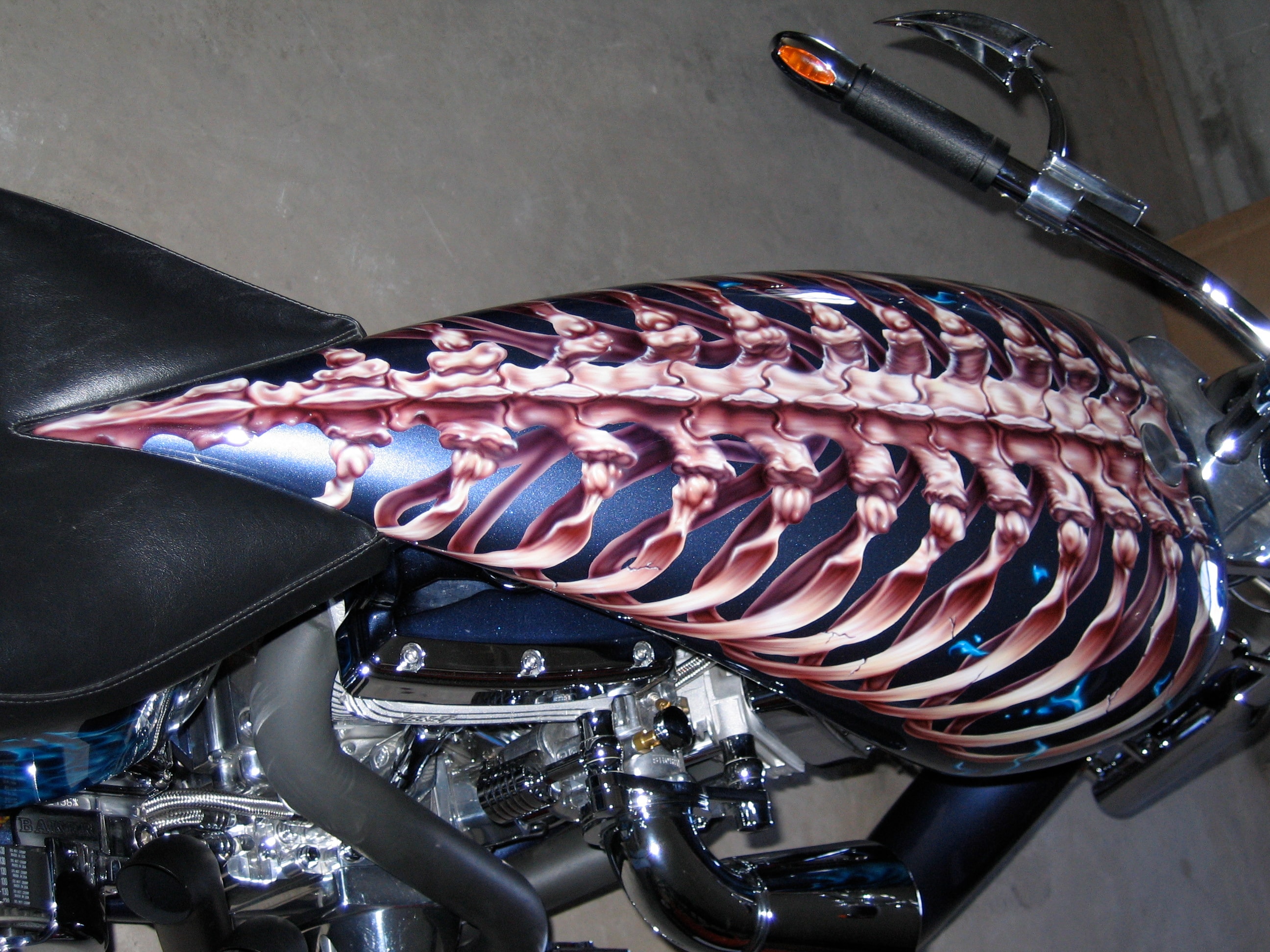 Devil's Advocate — tank side profile, full ribcage and spine running the length