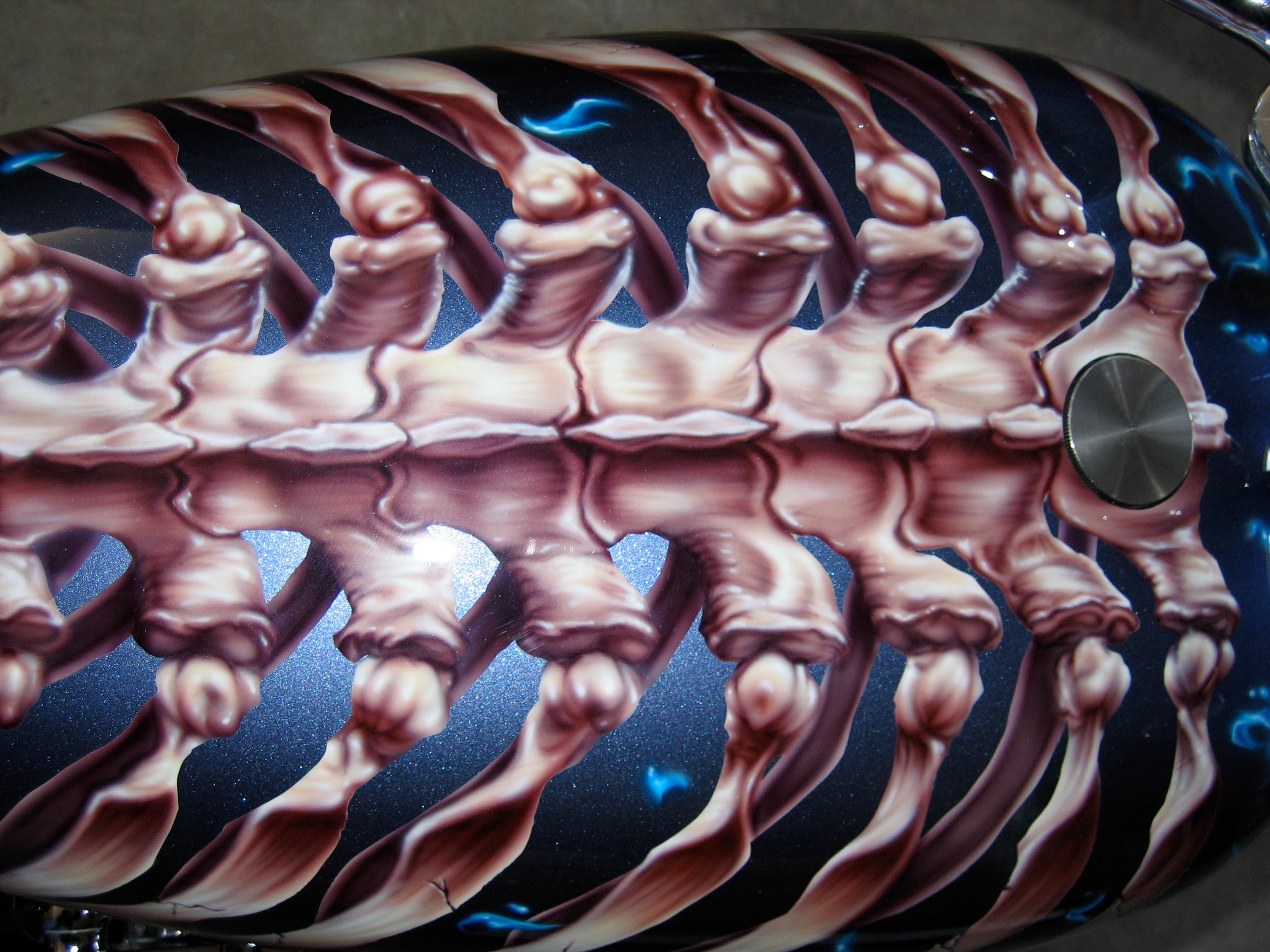 Devil's Advocate — tank top-down extreme closeup, full ribcage vertebrae detail