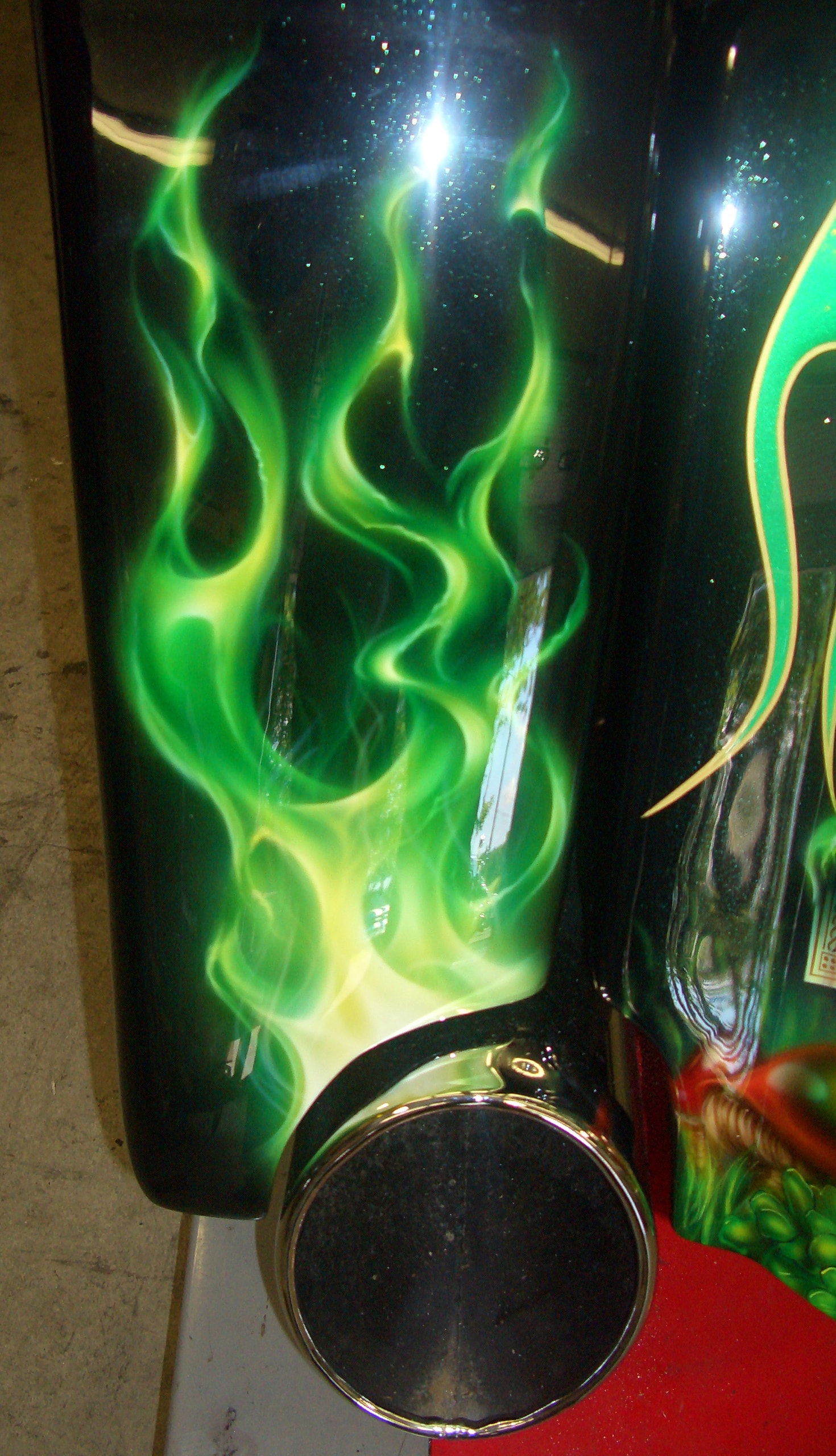 Irish Cadillac — saddlebag green ghost flames and chrome exhaust detail