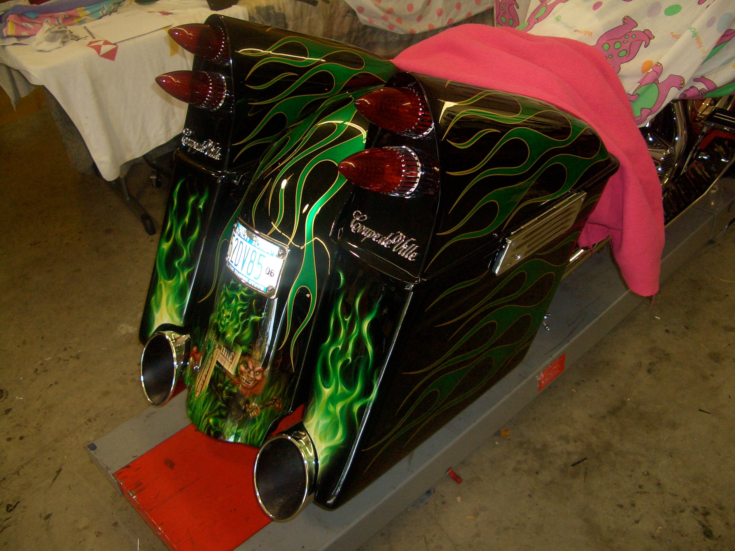 Irish Cadillac — rear three-quarter view at show, green flames over full bagger tail