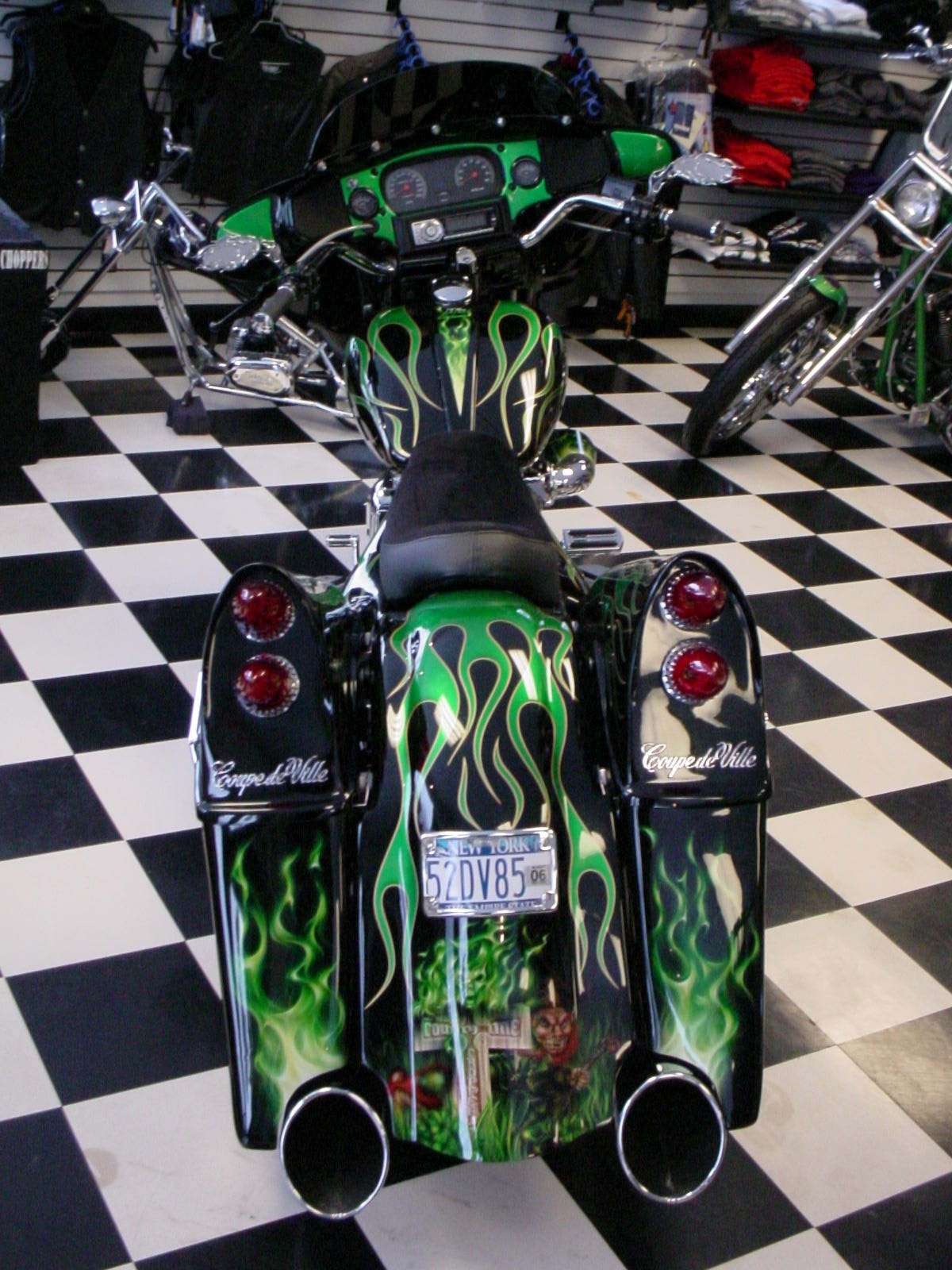 Irish Cadillac — straight rear view in showroom, Coupe de Ville script on bags