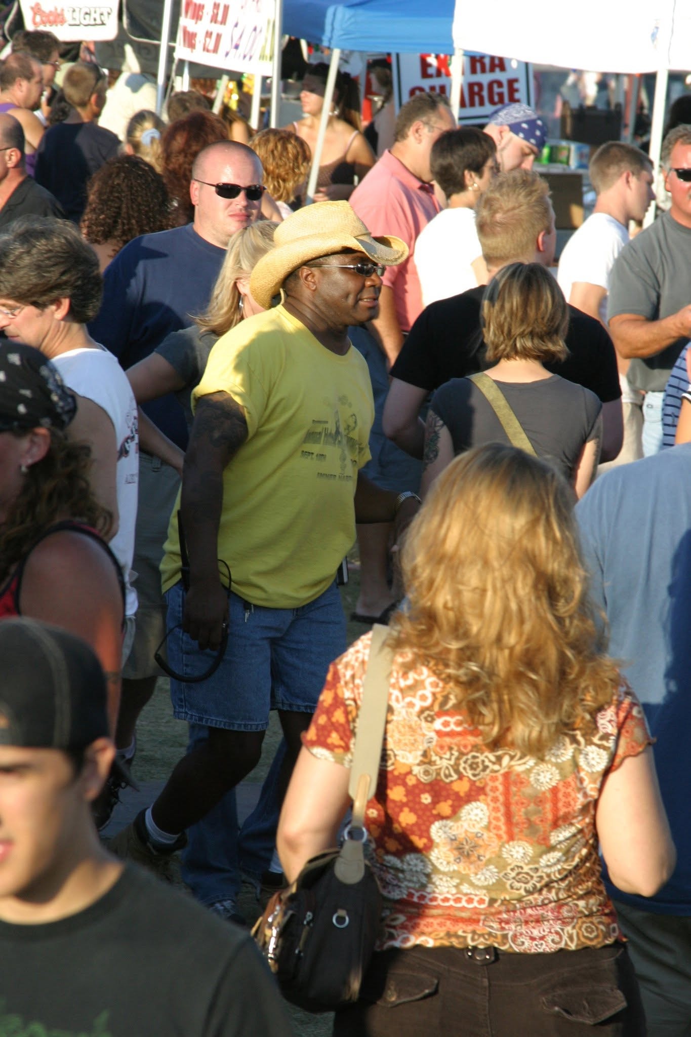 2006 Chick-N-Wing Festival — Al Miller in yellow shirt and cowboy hat moving through festival crowd
