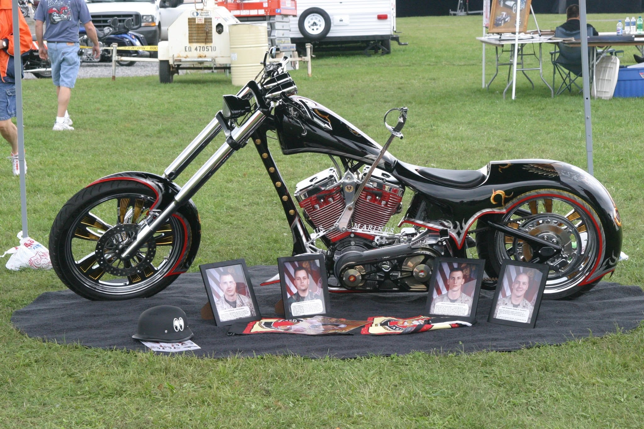 2006 Chick-N-Wing Festival — black US Marines tribute chopper with fallen soldier portraits displayed on grass