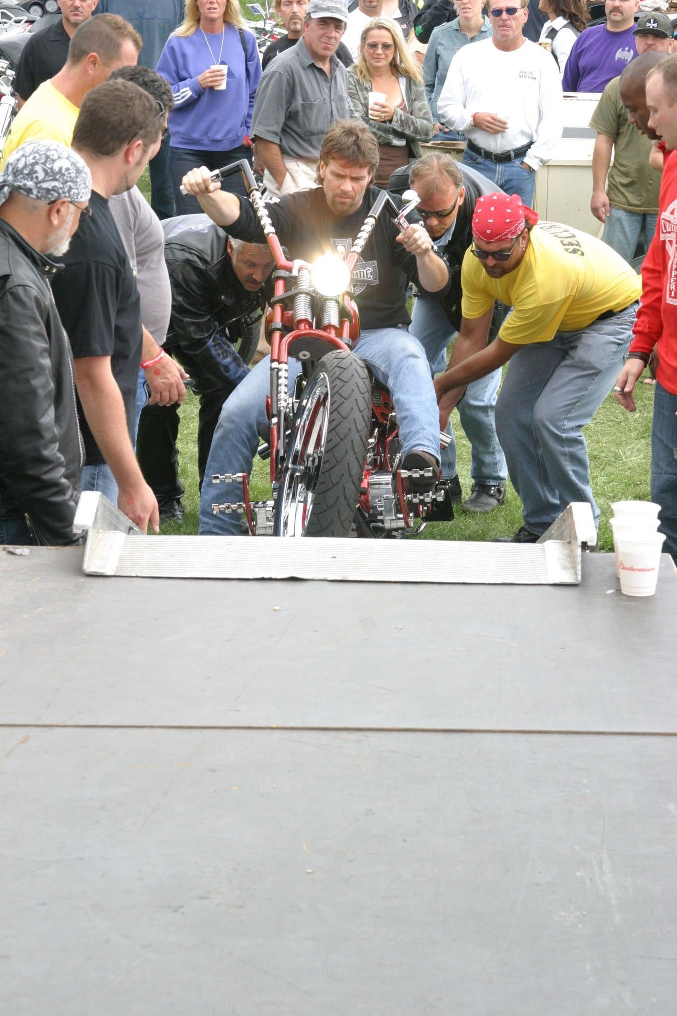 2006 Chick-N-Wing Festival — crowd surrounding red custom chopper being pushed up ramp onto stage
