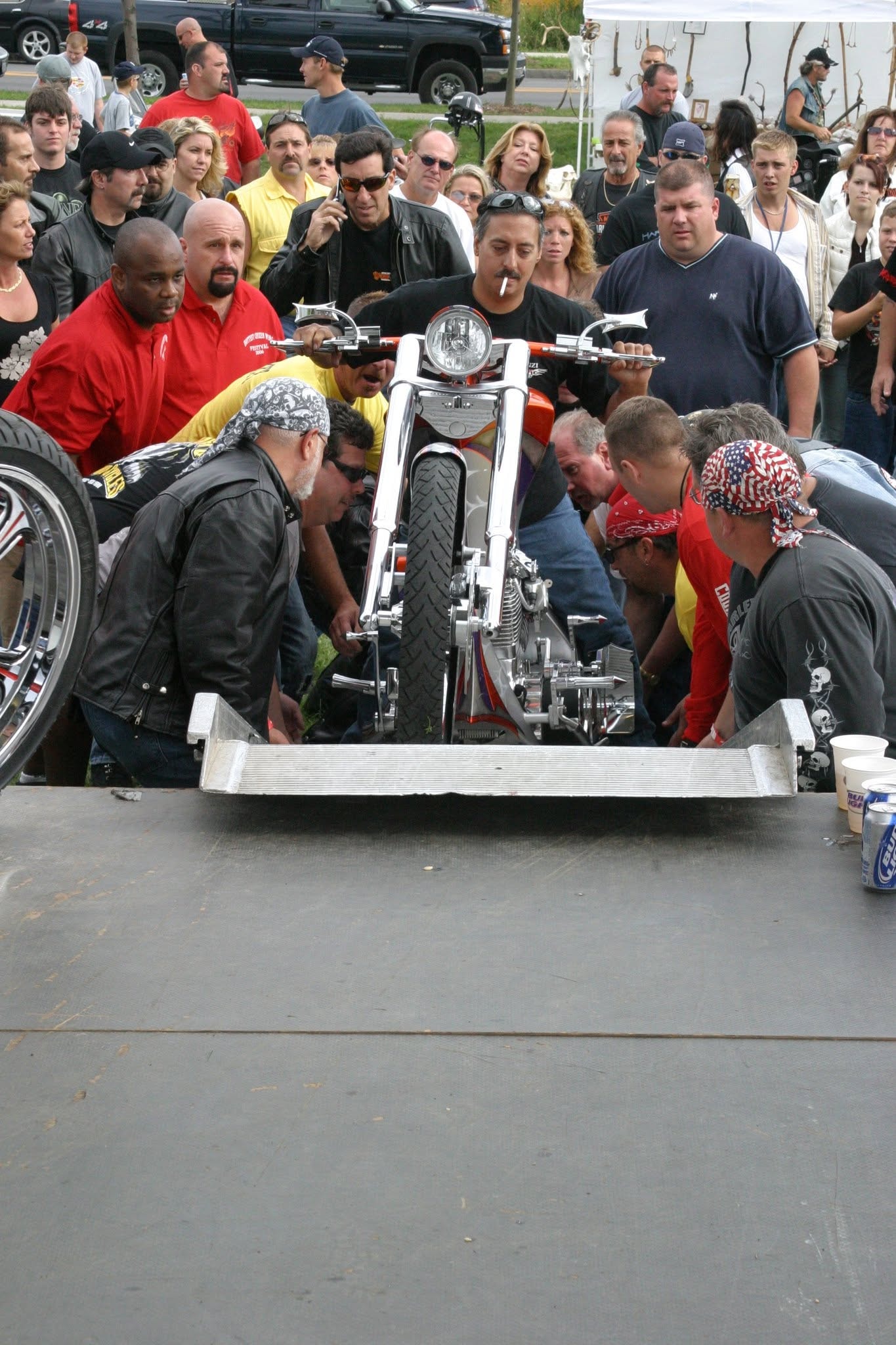 2006 Chick-N-Wing Festival — crowd surrounding orange and white custom chopper being loaded onto stage ramp