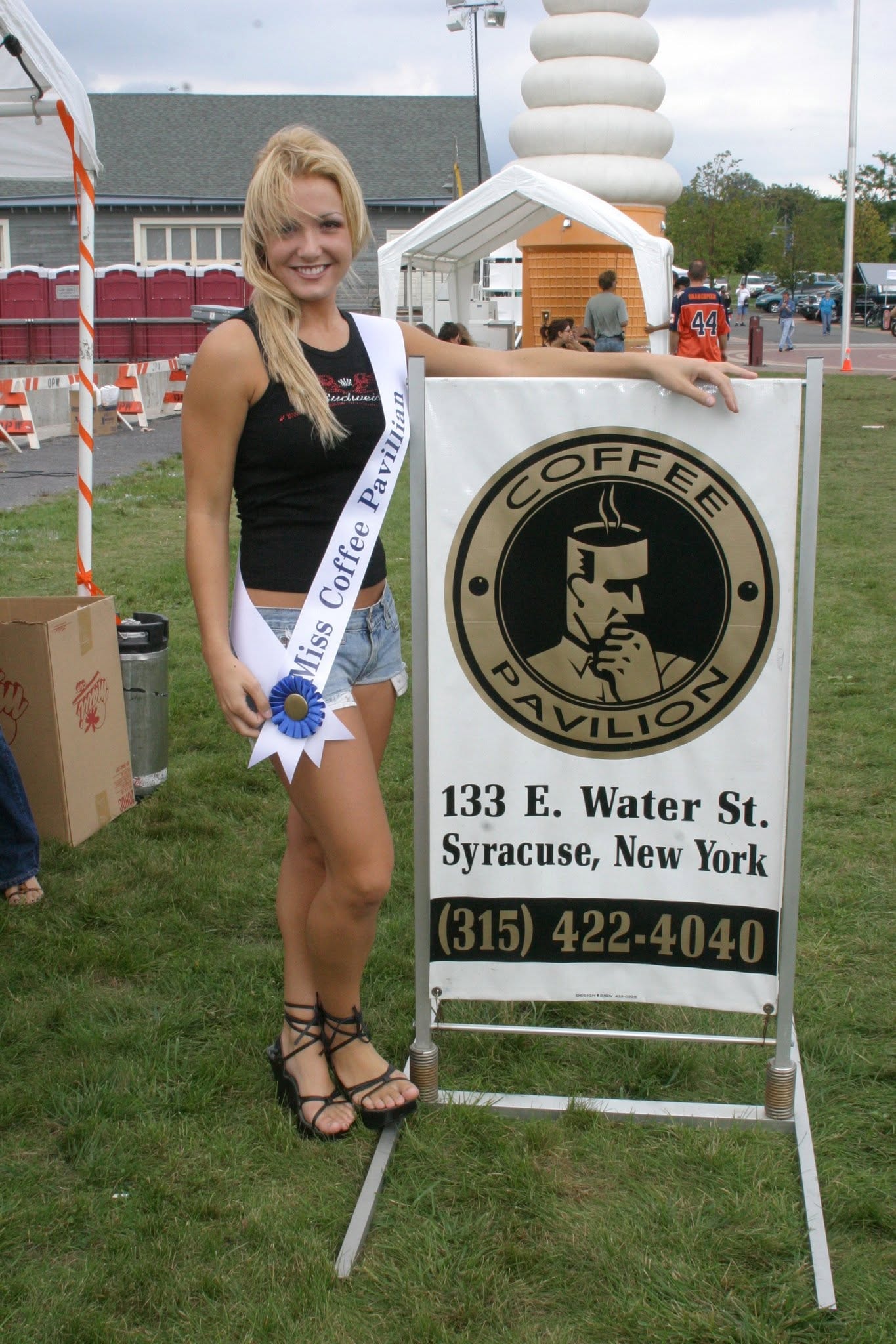 2006 Chick-N-Wing Festival — Miss Coffee Pavilion contestant posing with Coffee Pavilion sign at Inner Harbor