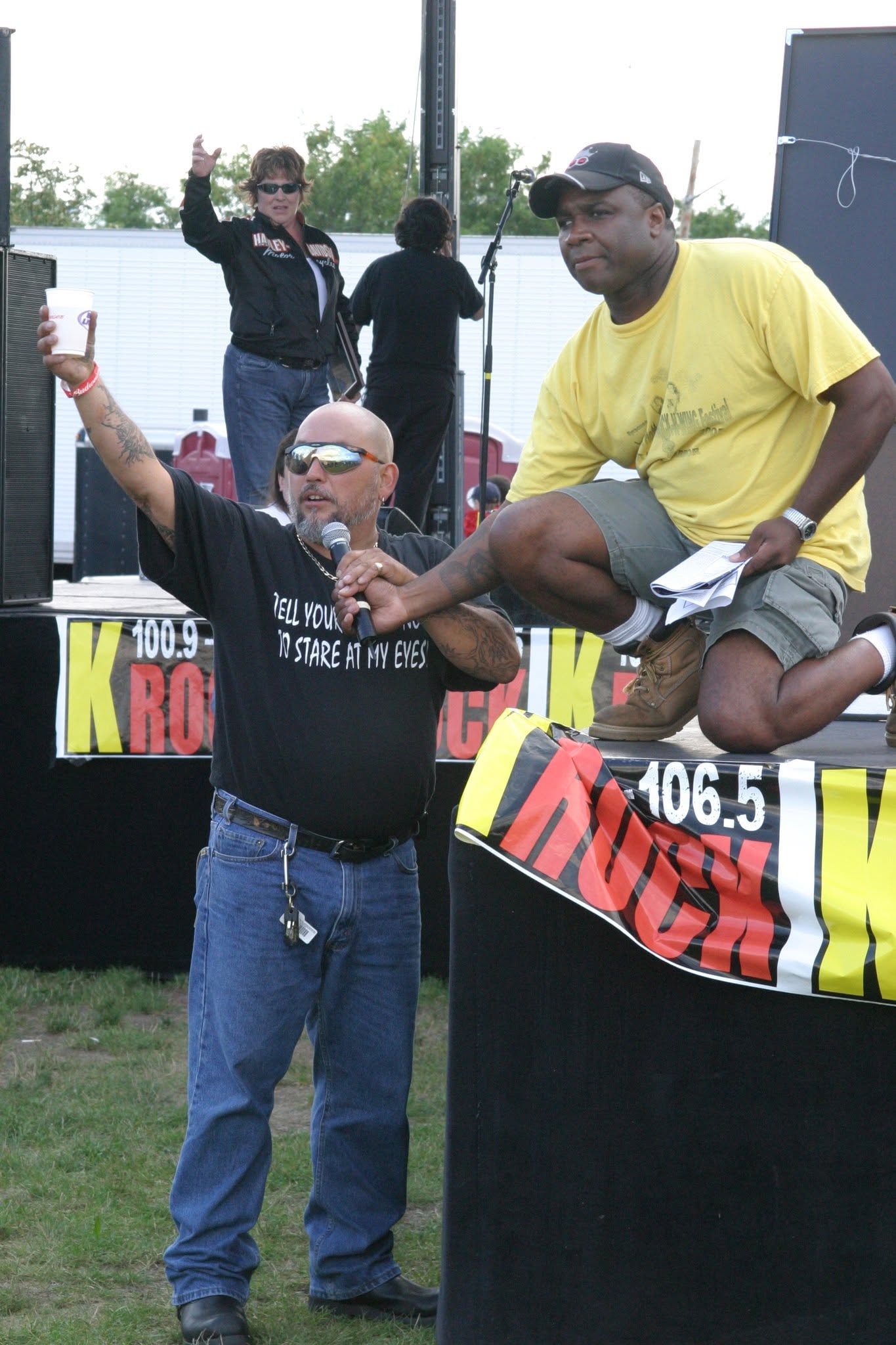 2006 Chick-N-Wing Festival — MC with microphone at K-Rock 100.9 stage with Al Miller raising cup in background