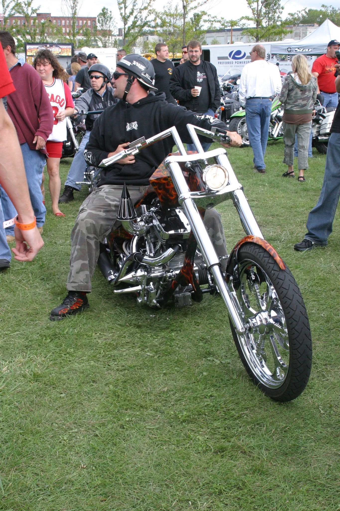 2006 Chick-N-Wing Festival — rider on chrome flame chopper with Preferred Powersports tent in background