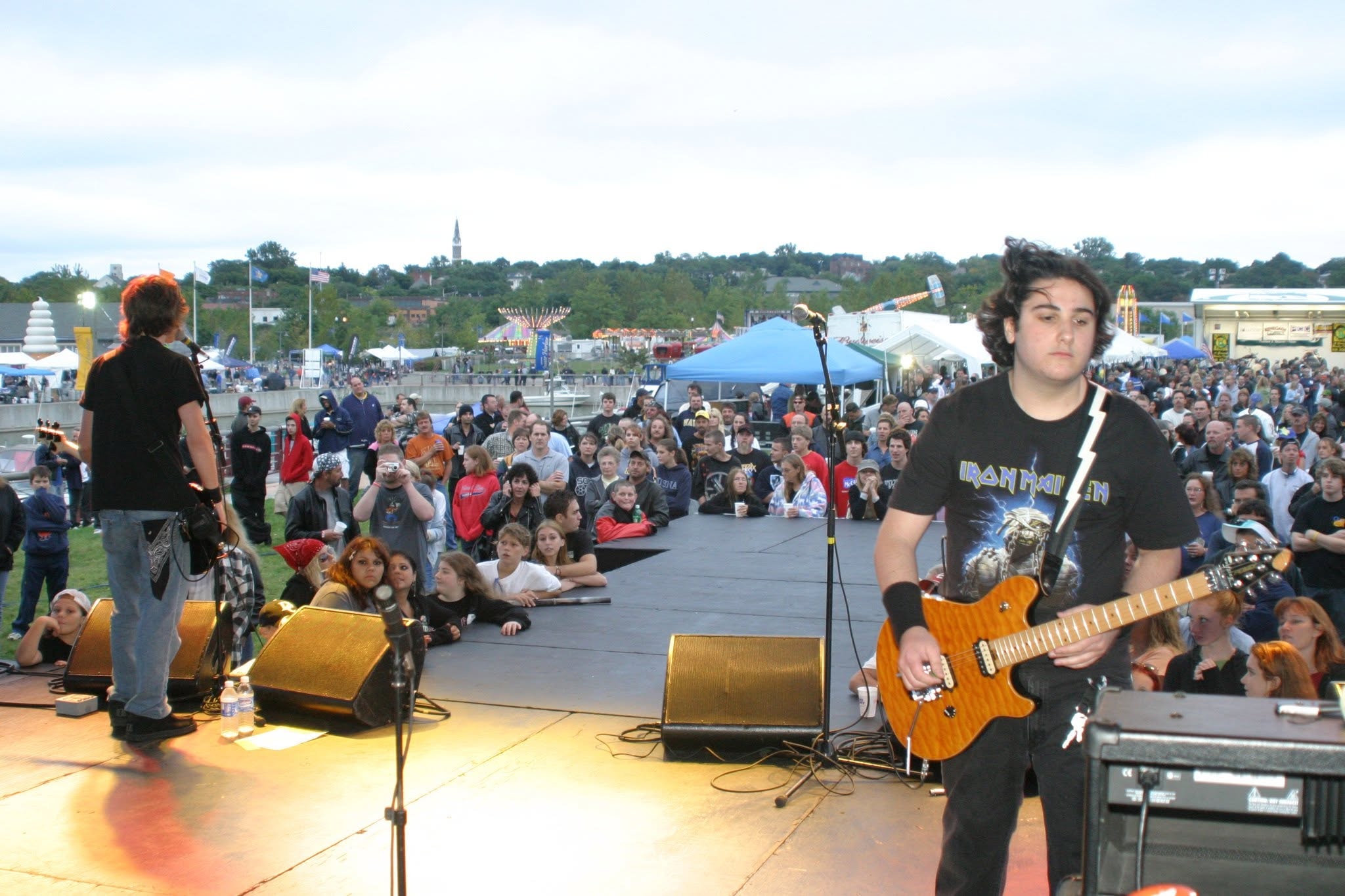 2006 Chick-N-Wing Festival — young guitarist in Iron Maiden shirt performing on stage with large crowd at Inner Harbor