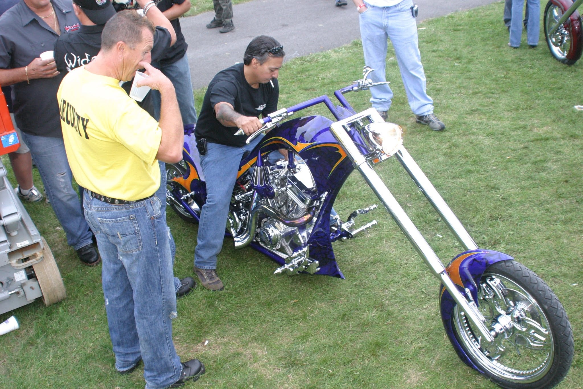 2006 Chick-N-Wing Festival — purple and gold custom chopper being inspected by security on festival grounds