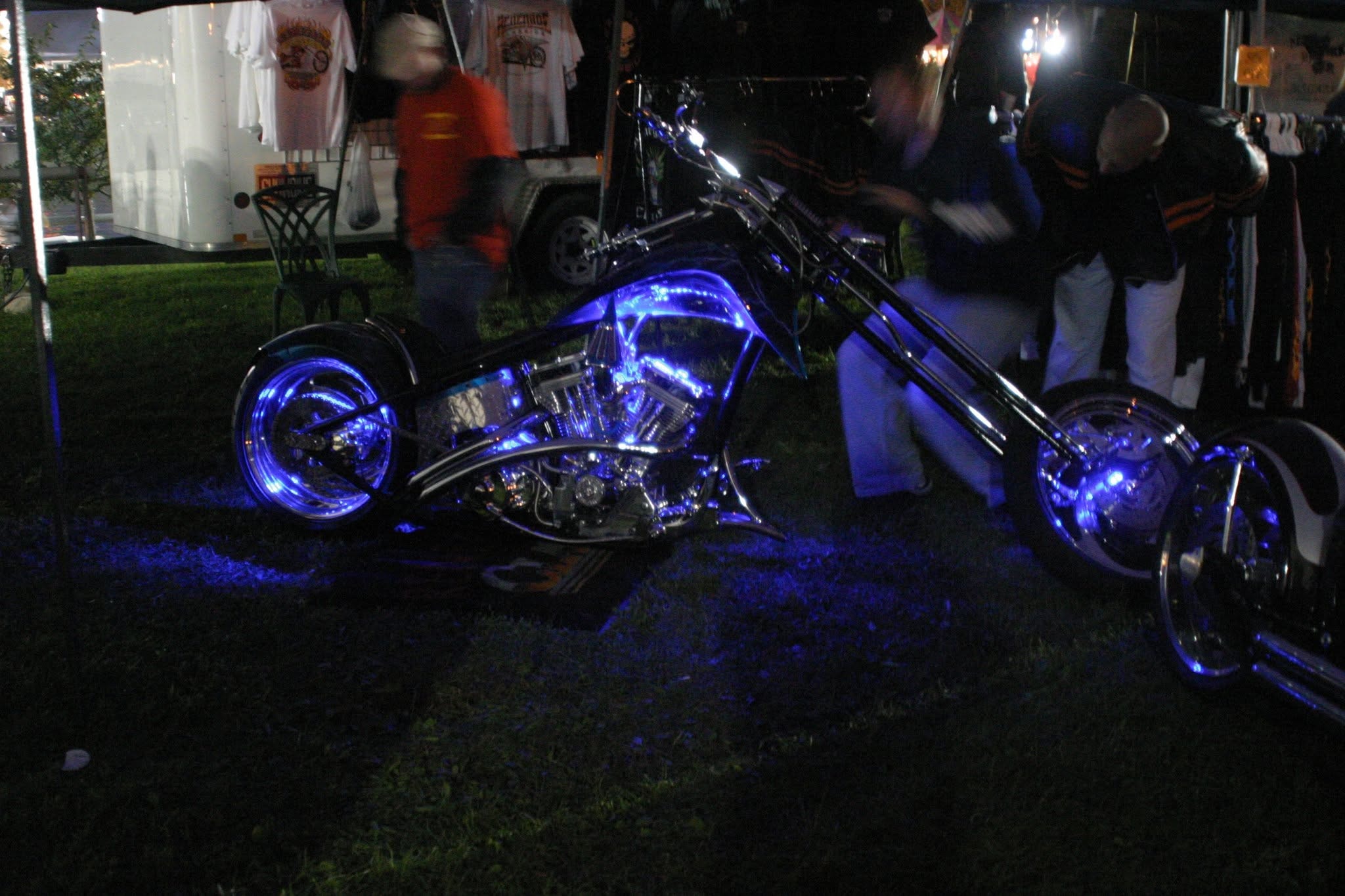 2006 Chick-N-Wing Festival — custom black chopper with blue LED lighting glowing on festival grass at night