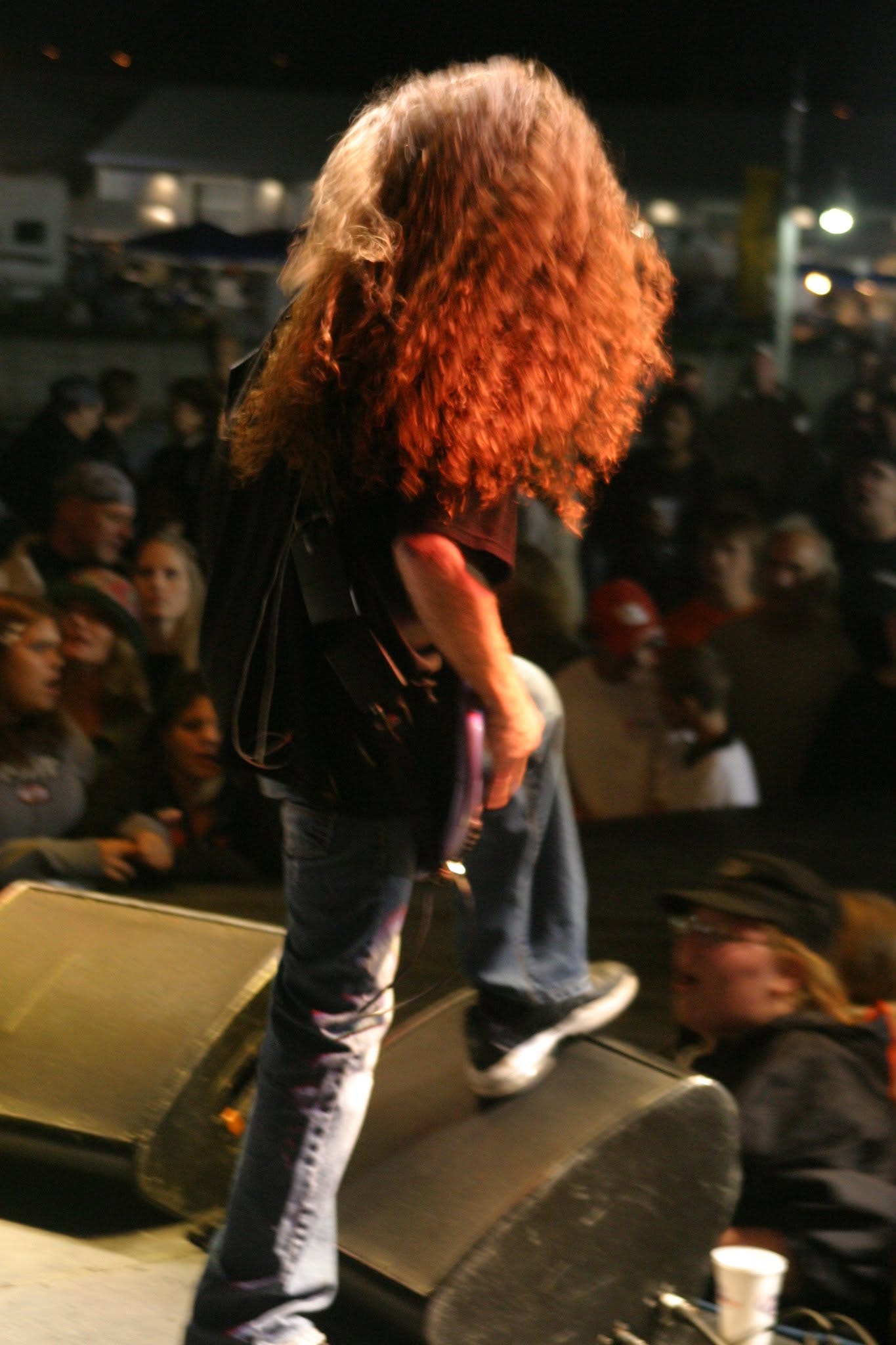 2006 Chick-N-Wing Festival — guitarist with long red hair performing on stage monitor at night with crowd
