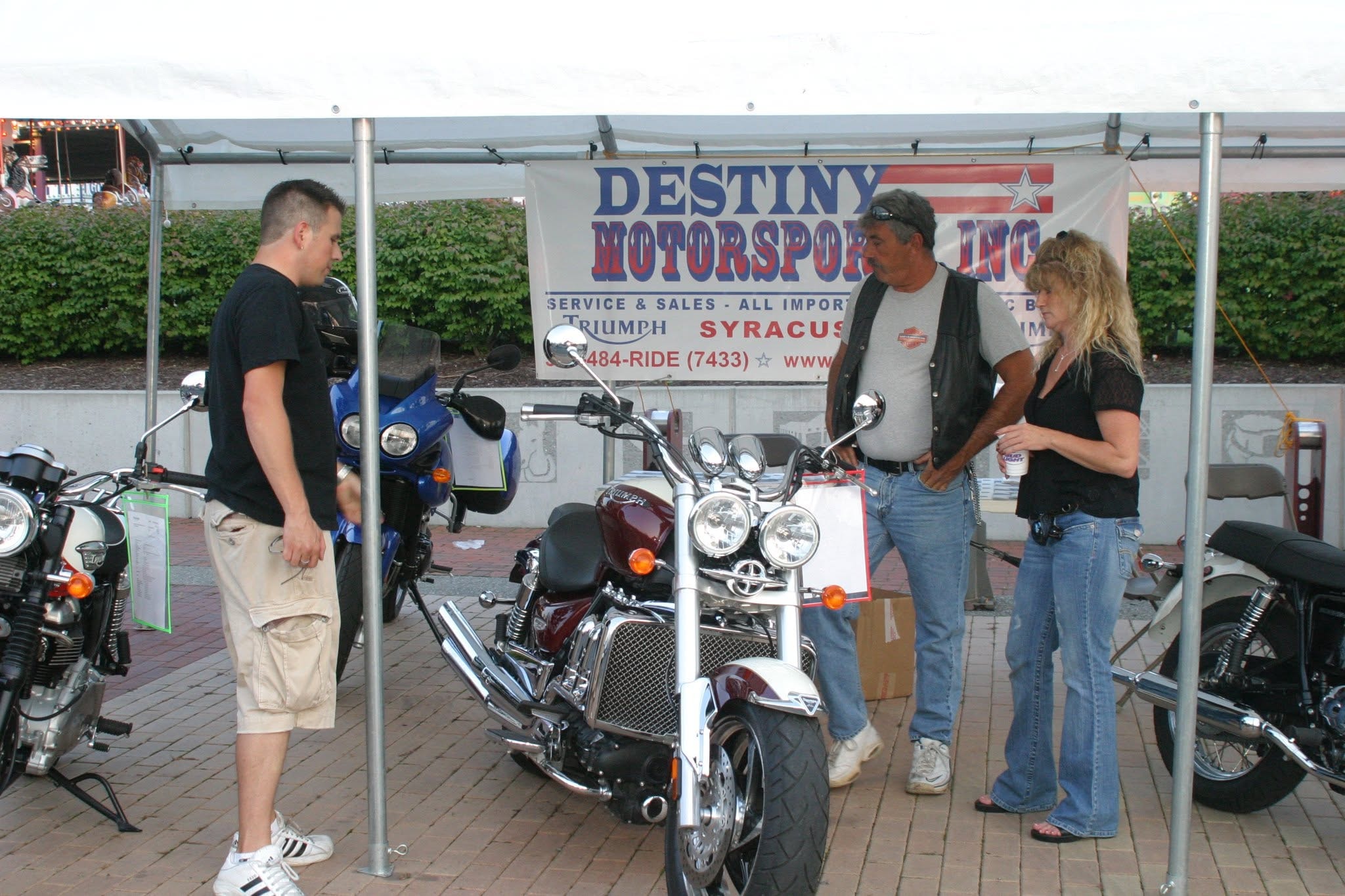 2008 Chick-N-Wing Festival — Destiny Motorsports Inc. display tent with Triumph motorcycles