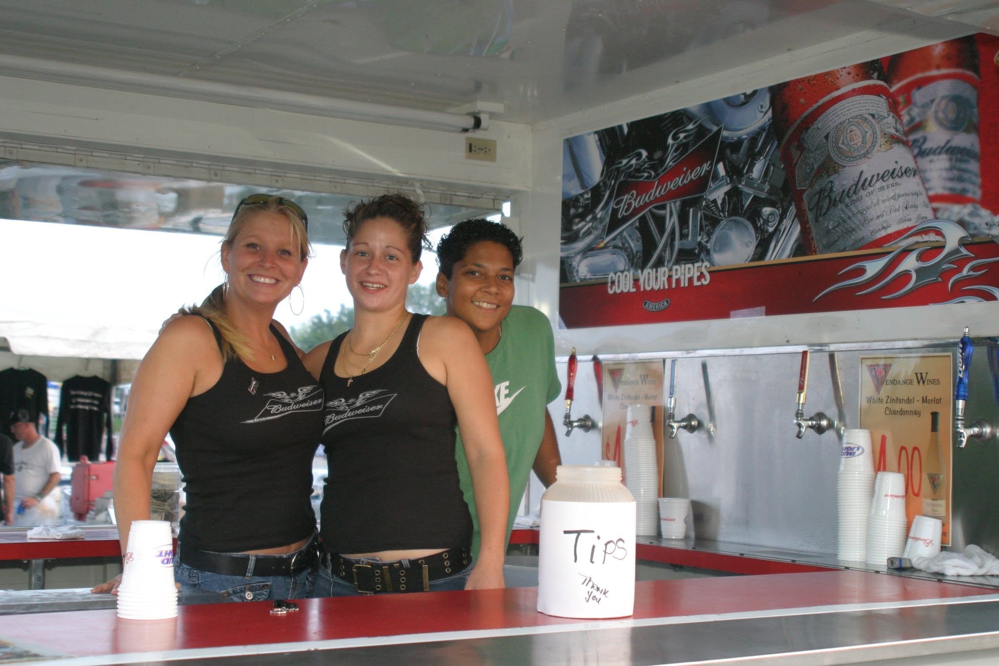 2008 Chick-N-Wing Festival — three Budweiser bar staff smiling at beer trailer