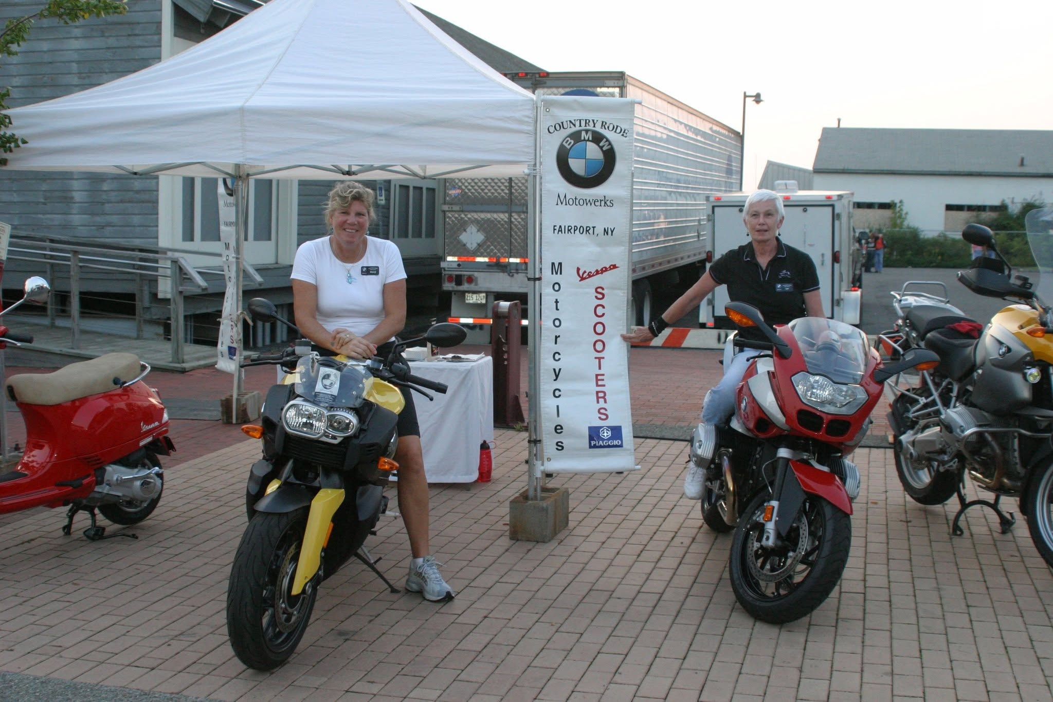 2008 Chick-N-Wing Festival — Country Rode BMW Motowerks display with two women and motorcycles