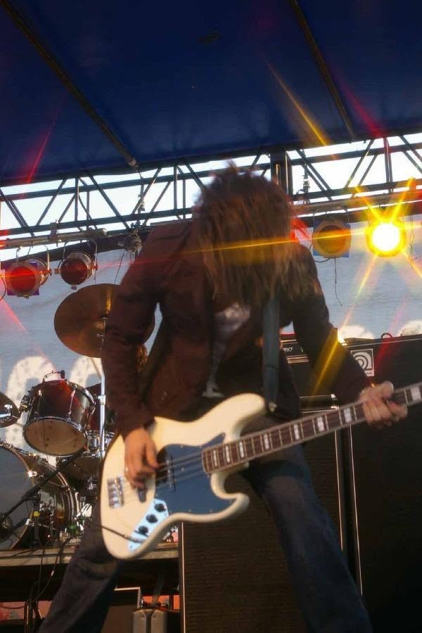 2008 Chick-N-Wing Festival — bassist performing on outdoor stage with concert lighting