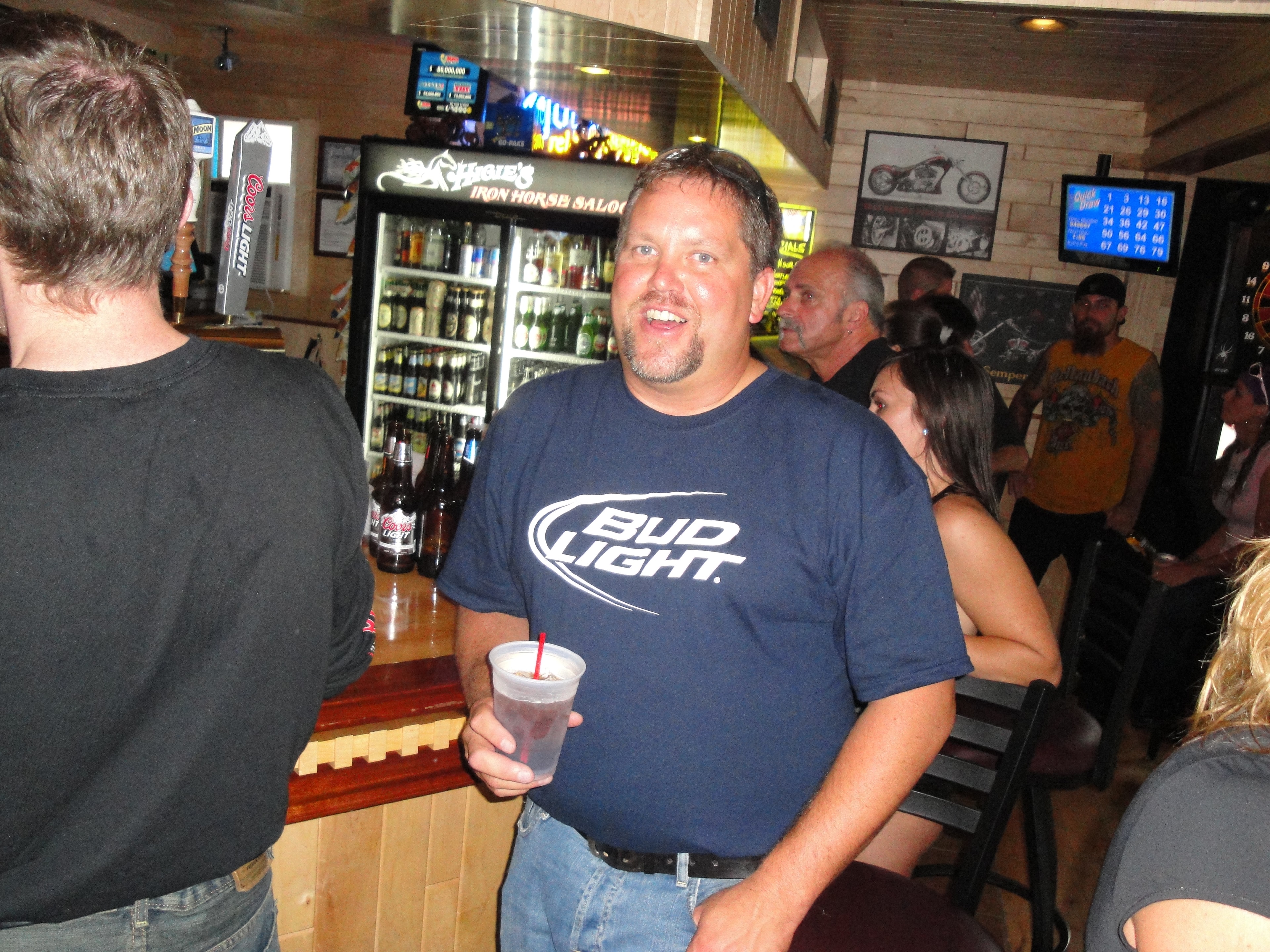 Higie's Iron Horse Saloon Summer BBQ Series — man in Bud Light shirt smiling inside the Iron Horse Saloon