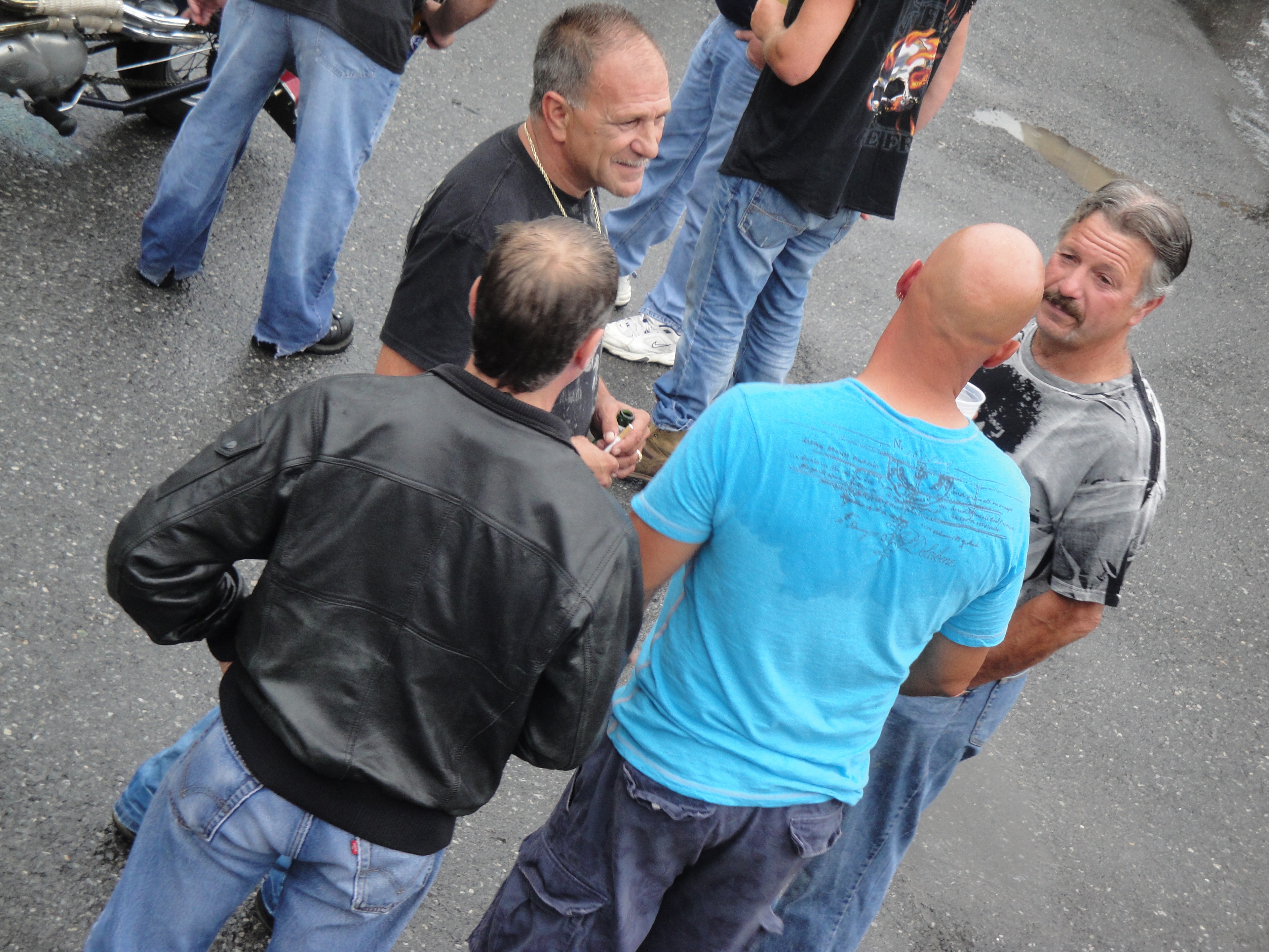 Higie's Iron Horse Saloon Summer BBQ Series — four men chatting in parking lot at the event