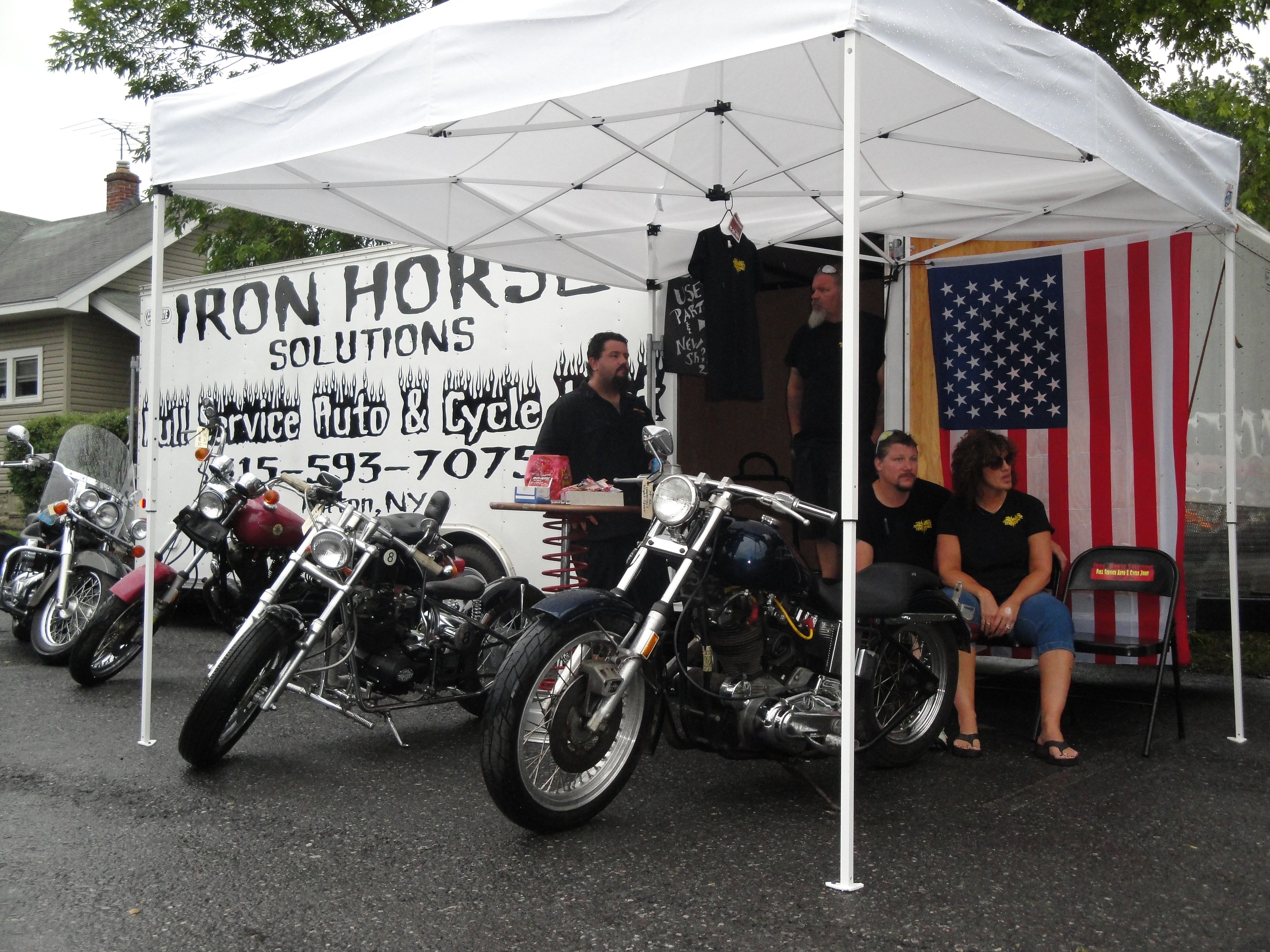 Higie's Iron Horse Saloon Summer BBQ Series — Iron Horse Solutions auto and cycle booth with motorcycles under white tent