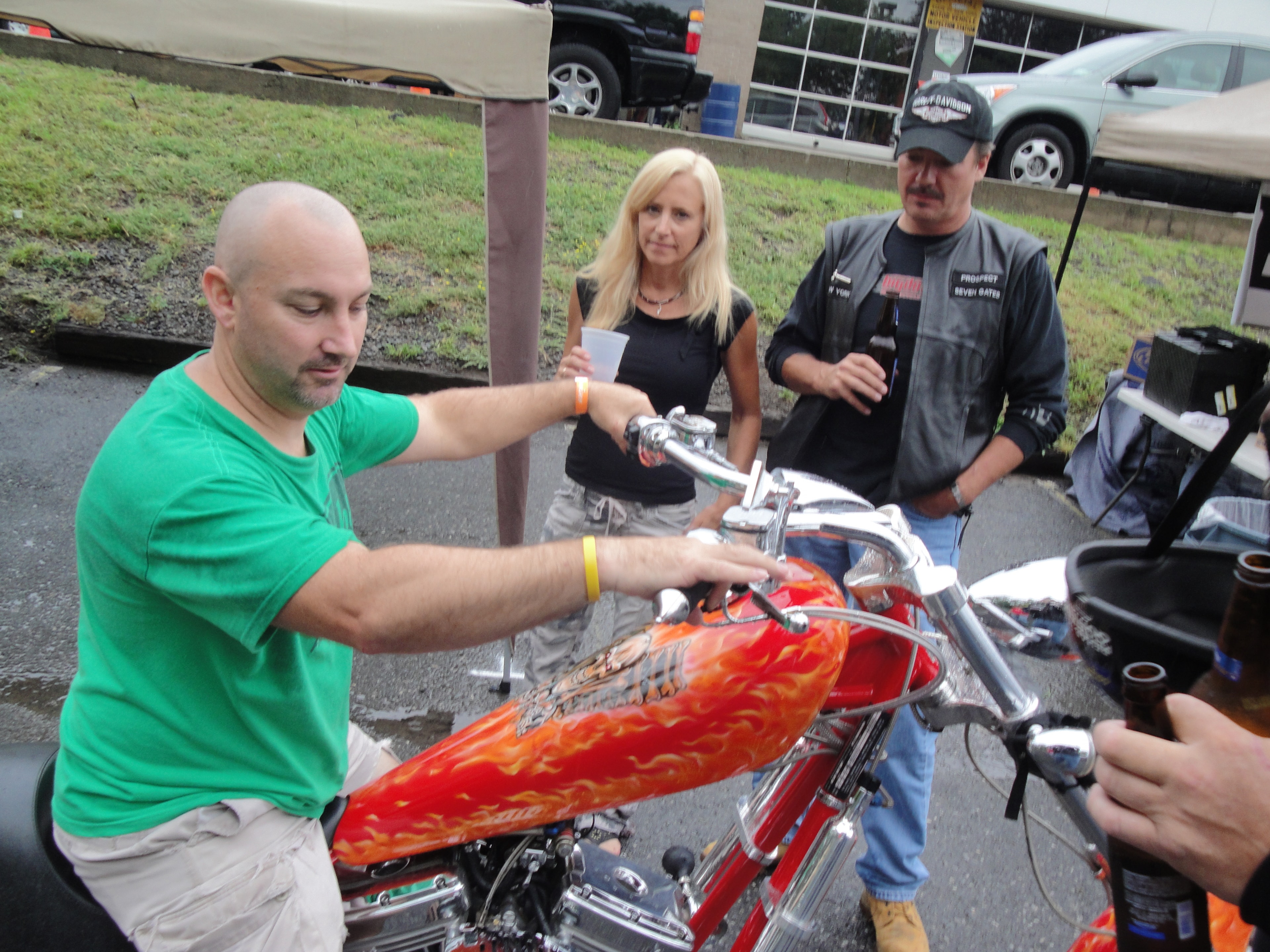 Higie's Iron Horse Saloon Summer BBQ Series — people admiring red flame chopper at the event