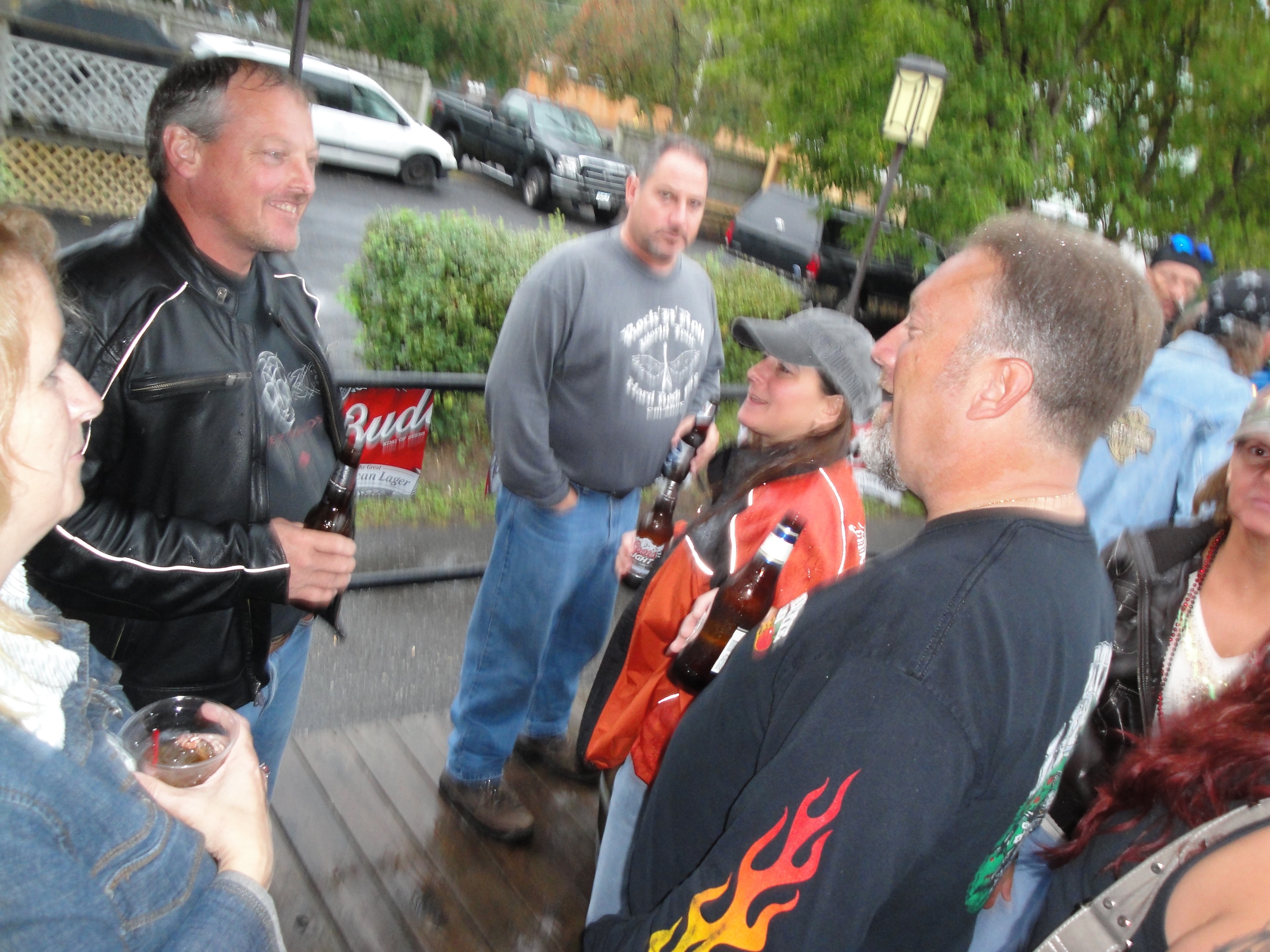 Higie's Iron Horse Saloon Summer BBQ Series — bikers chatting on the outdoor deck with Budweiser sign