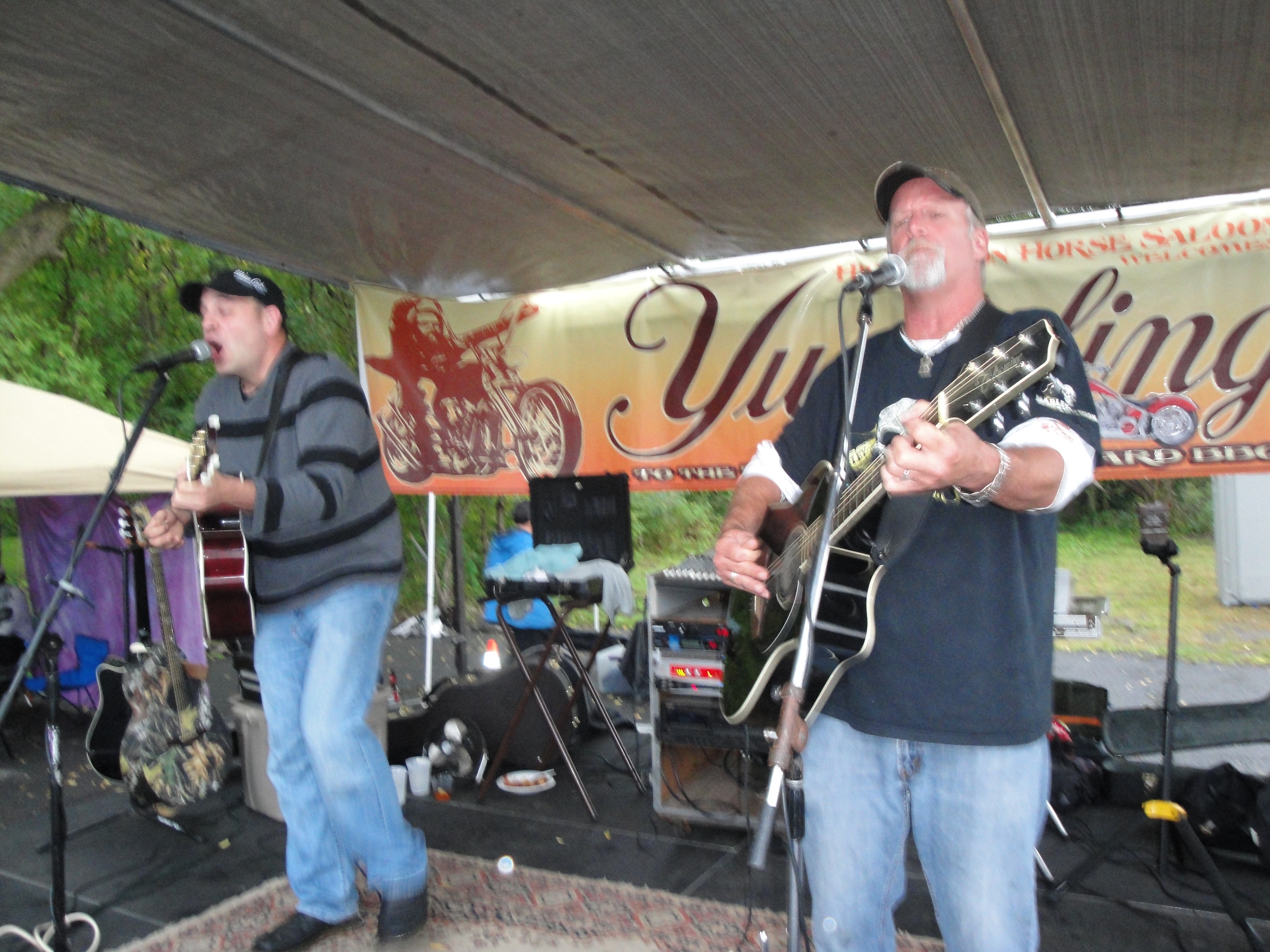 Higie's Iron Horse Saloon Summer BBQ Series — two guitarists performing under Yuengling Iron Horse Saloon banner