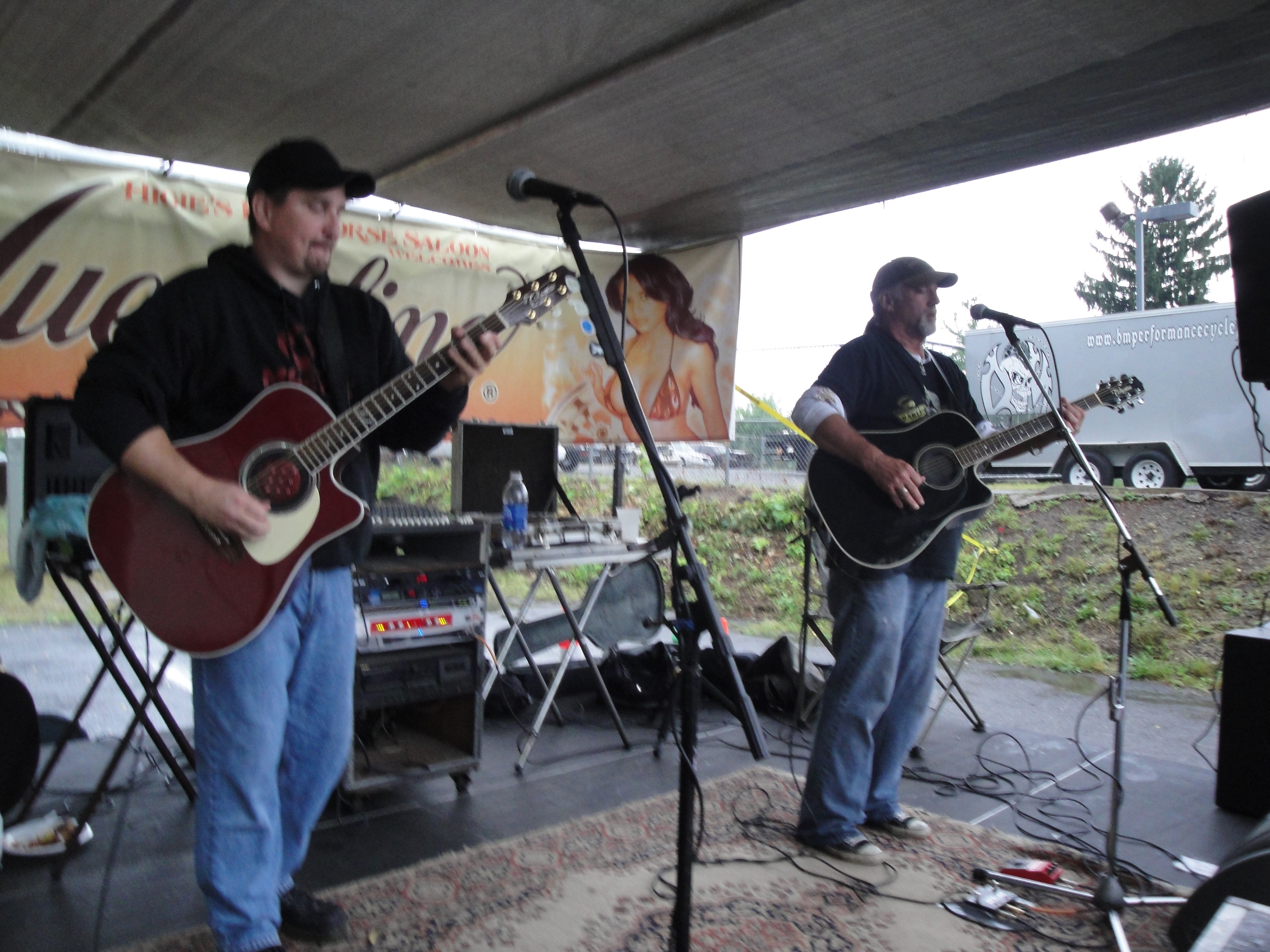 Higie's Iron Horse Saloon Summer BBQ Series — two guitarists performing under Higie's Iron Horse Saloon welcome banner