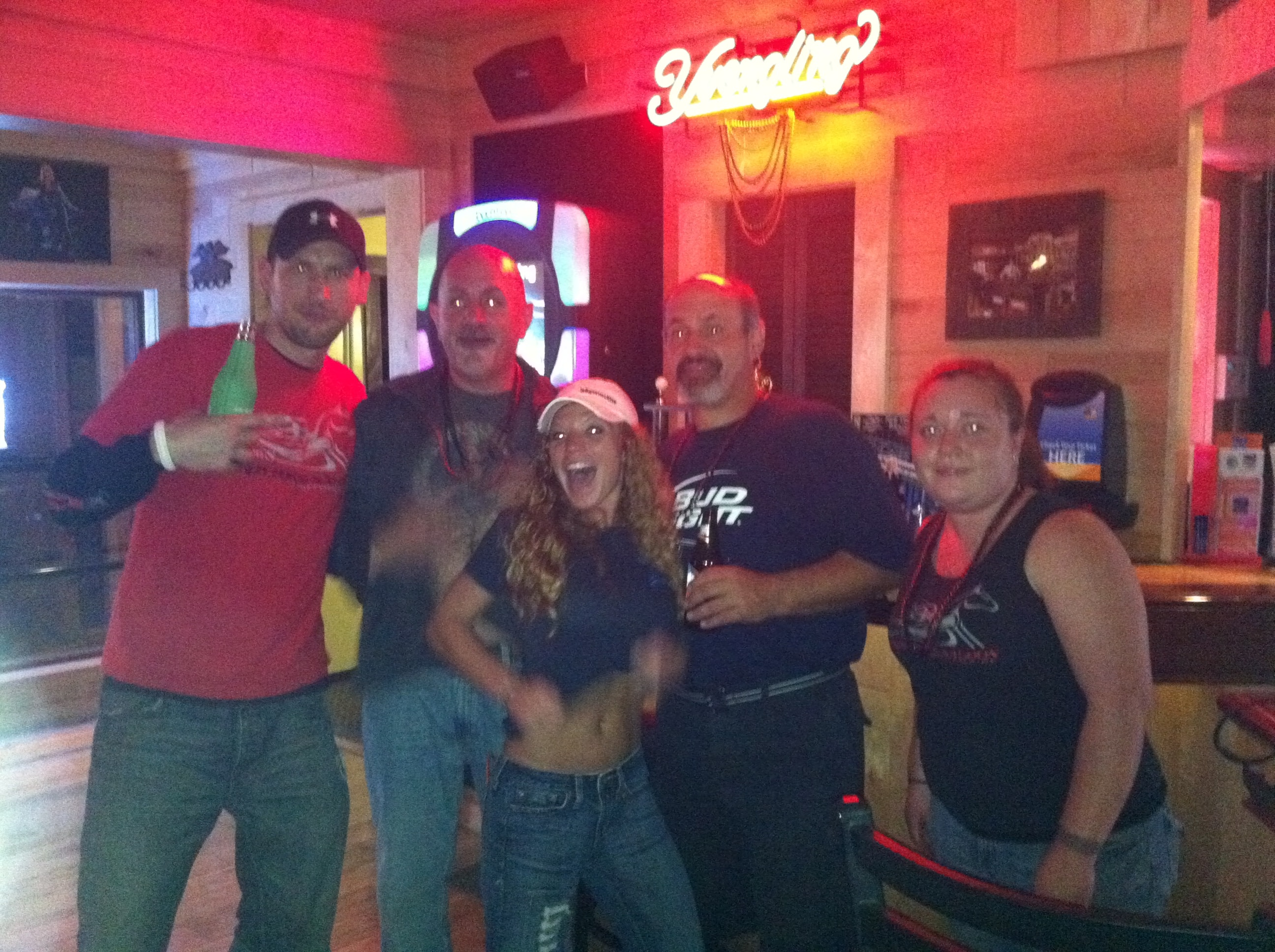 Higie's Iron Horse Saloon Summer BBQ Series — five people posing inside the Iron Horse Saloon under Yuengling neon sign