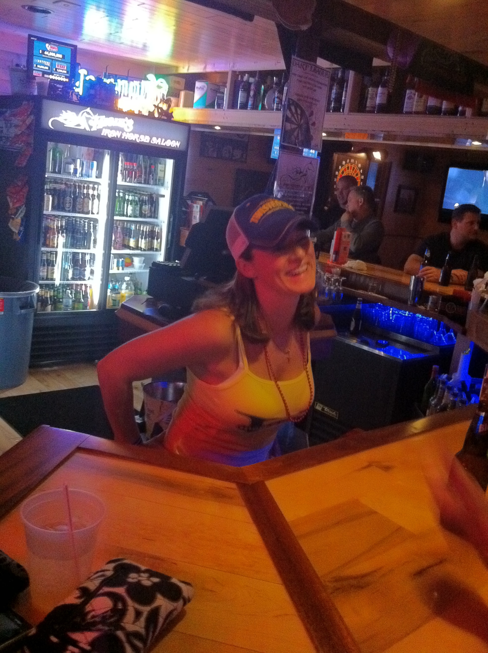 Higie's Iron Horse Saloon Summer BBQ Series — bartender in yellow tank top smiling behind the Iron Horse Saloon bar