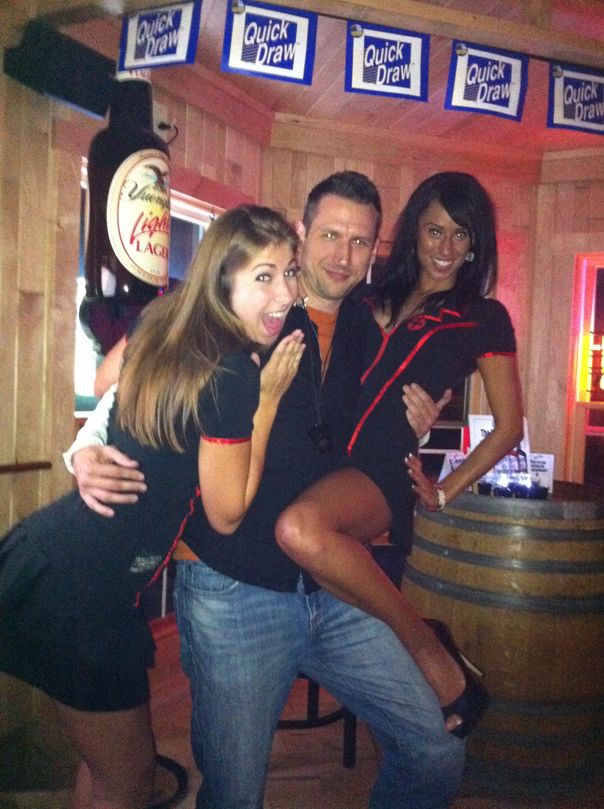 Higie's Iron Horse Saloon Summer BBQ Series — three people posing together inside the Iron Horse Saloon near Quick Draw lottery machine