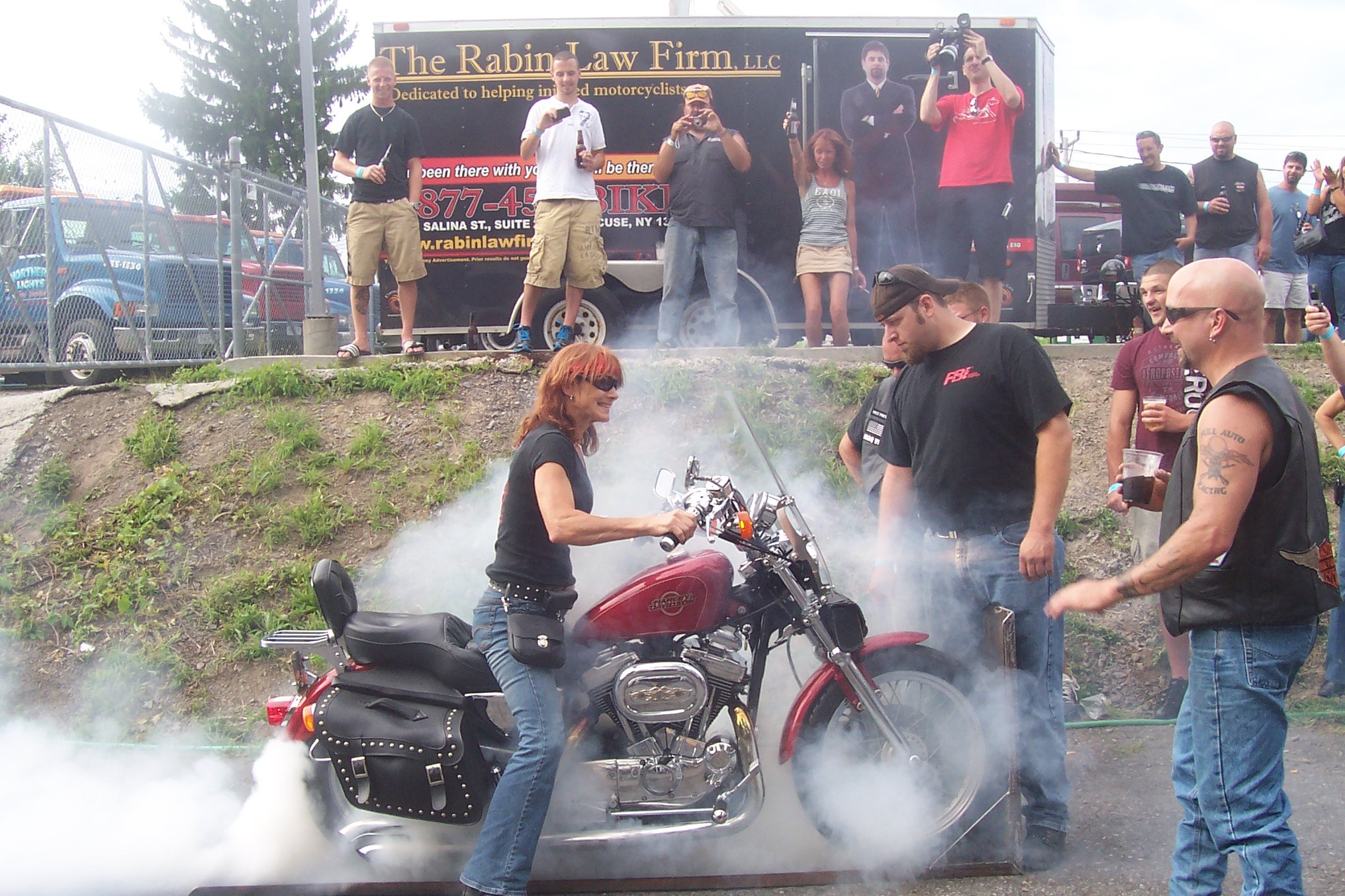Higie's Iron Horse Saloon Summer BBQ Series — woman burnout on red Harley