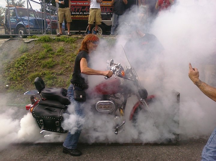 Higie's Iron Horse Saloon Summer BBQ Series — woman burnout red motorcycle smoke