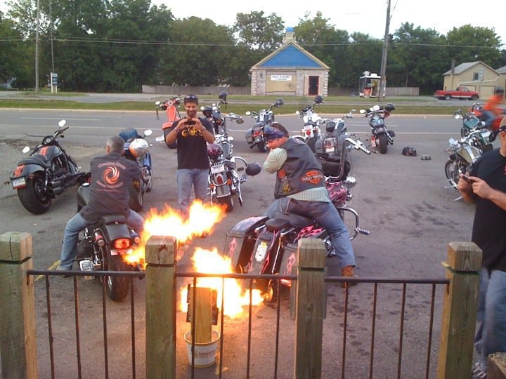 Higie's Iron Horse Saloon Summer BBQ Series — fire barrel with riders gathered around