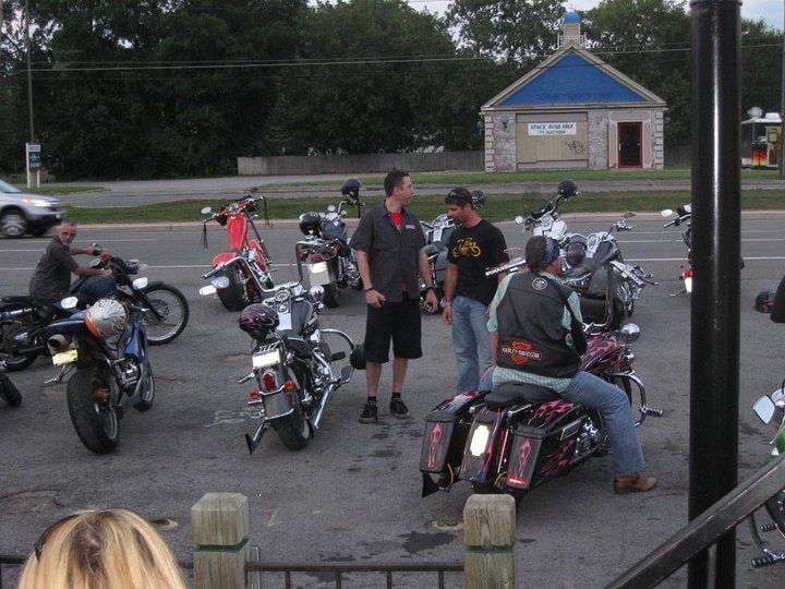 Higie's Iron Horse Saloon Summer BBQ Series — riders gathered in parking lot at dusk