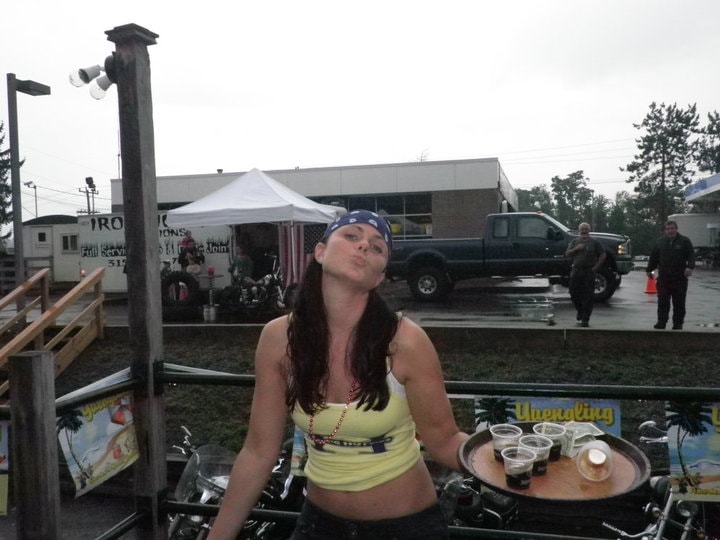 Higie's Iron Horse Saloon Summer BBQ Series — woman with bandana serving drinks outside