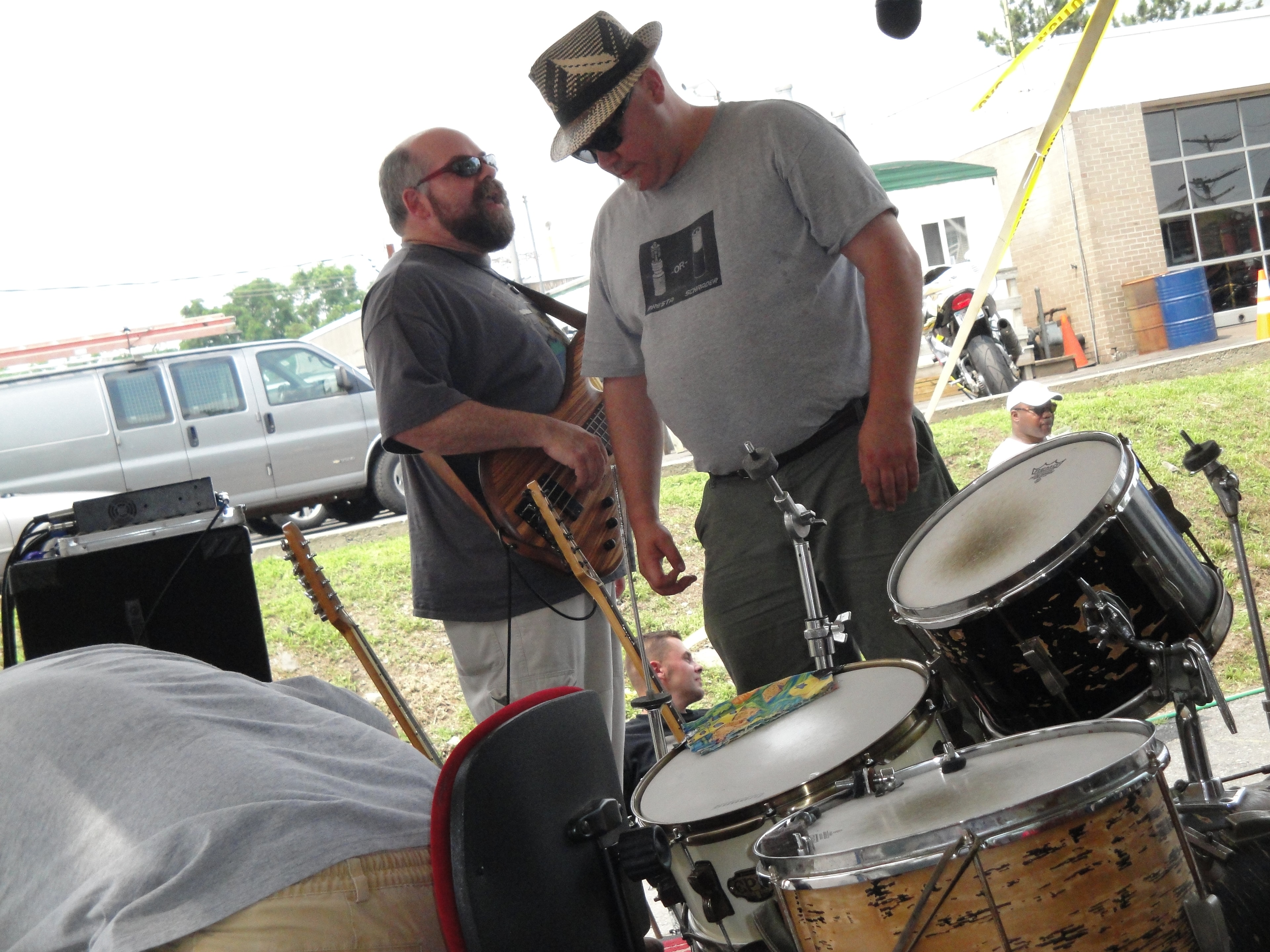 Higie's Iron Horse Saloon Summer BBQ Series — bassist and drummer setting up on stage