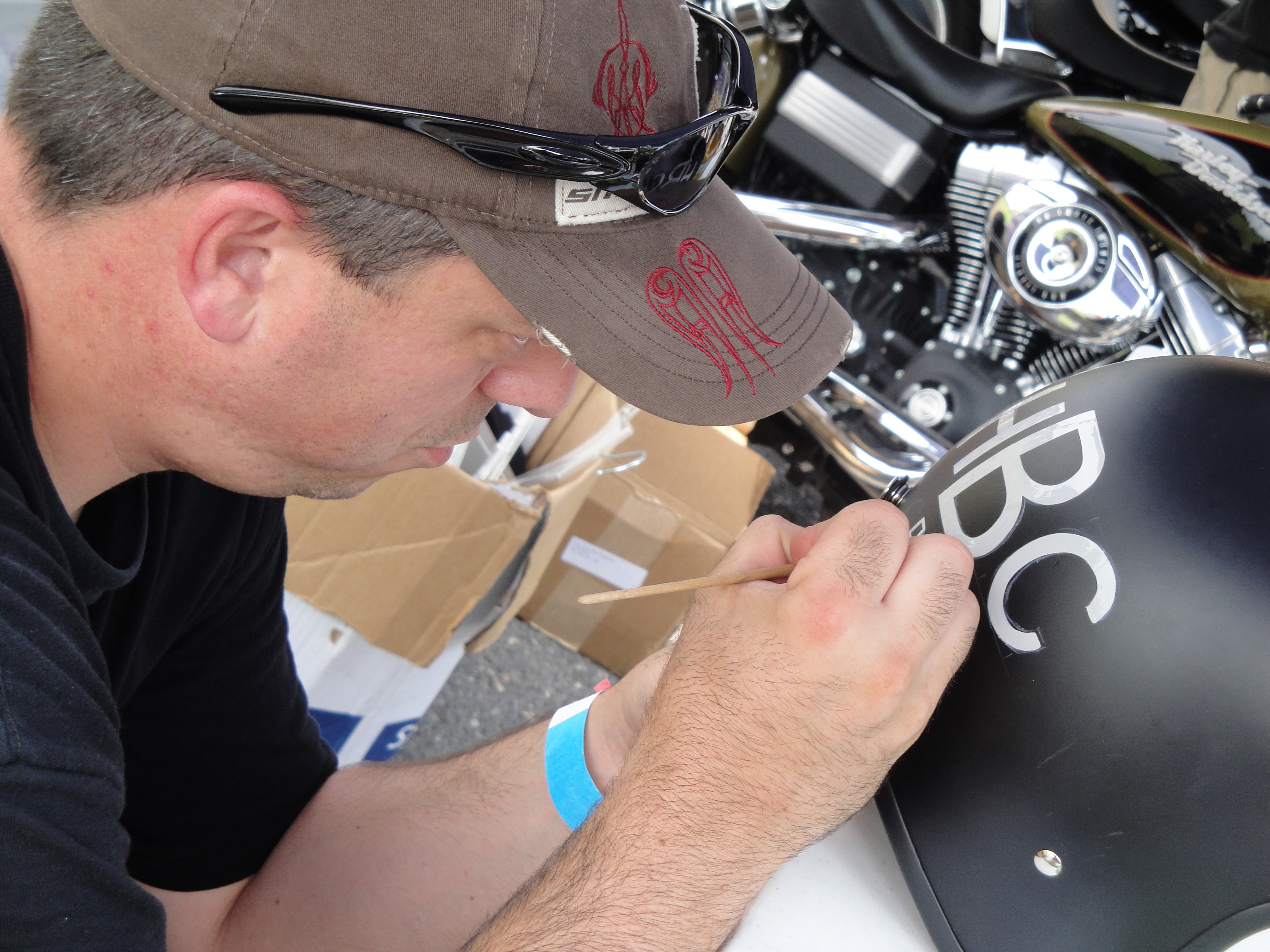 Higie's Iron Horse Saloon Summer BBQ Series — Marcus pinstriping a helmet at the event