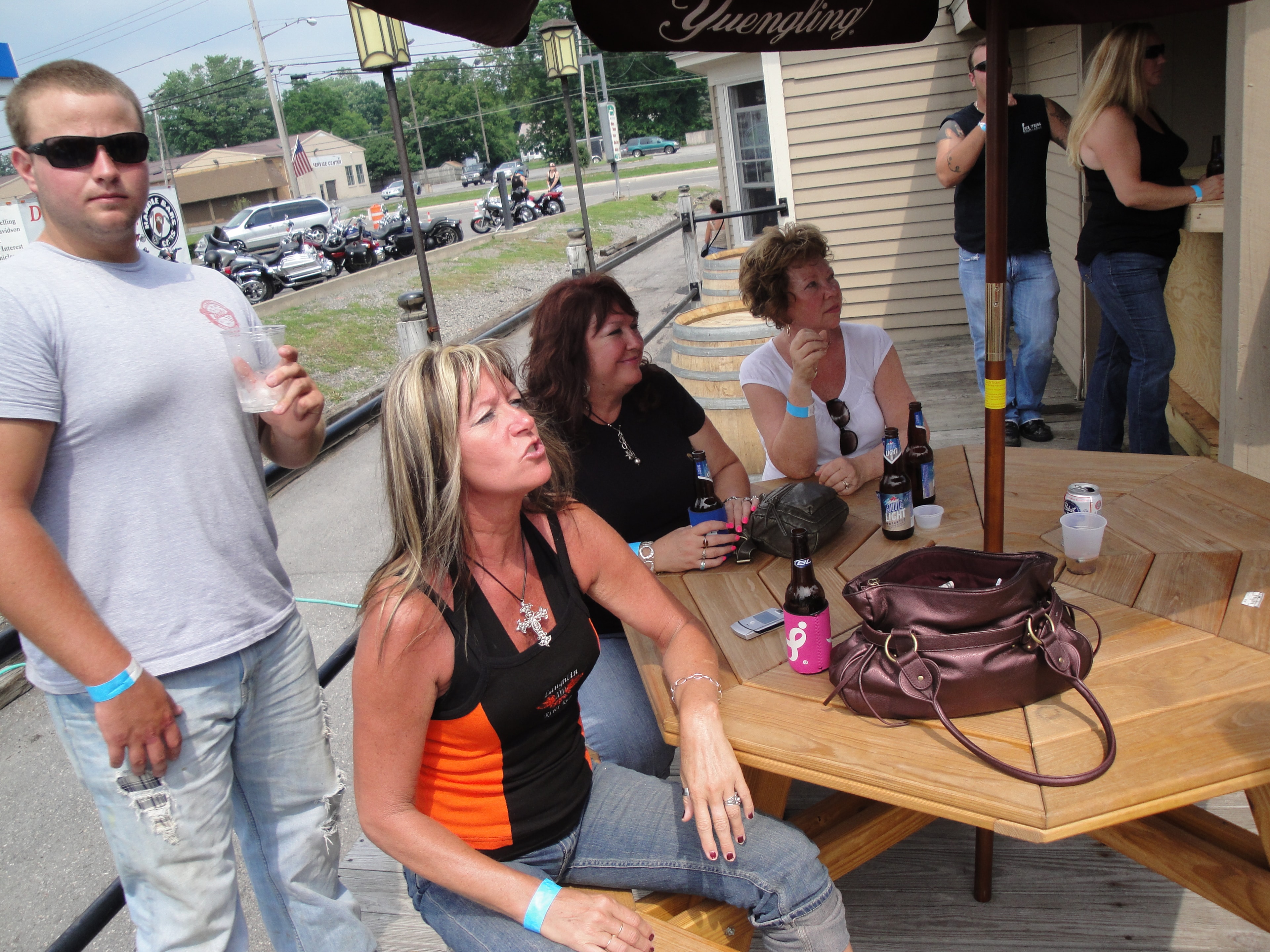 Higie's Iron Horse Saloon Summer BBQ Series — women relaxing at Yuengling patio tables