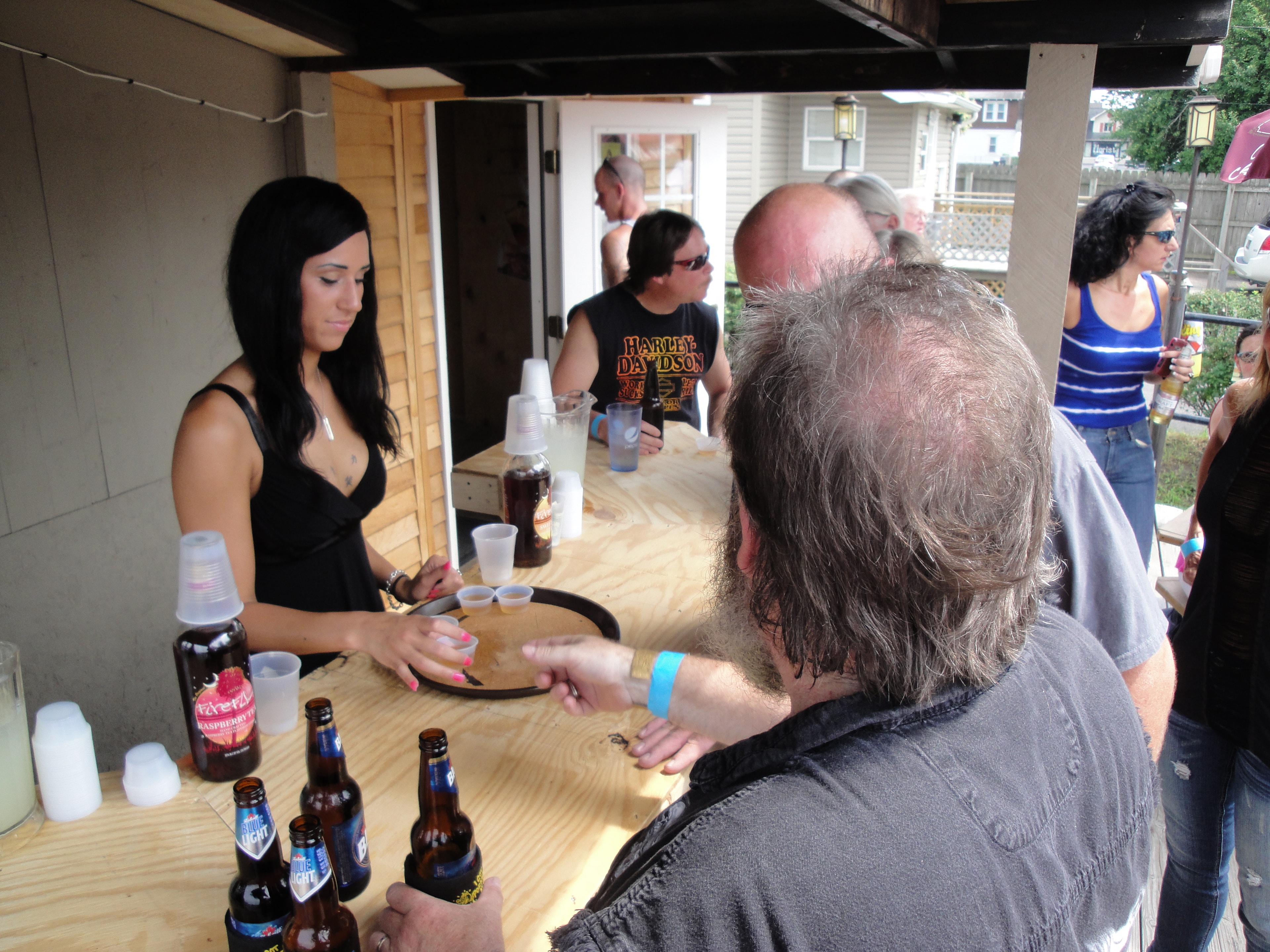 Higie's Iron Horse Saloon Summer BBQ Series — bartender serving shots at the outdoor bar