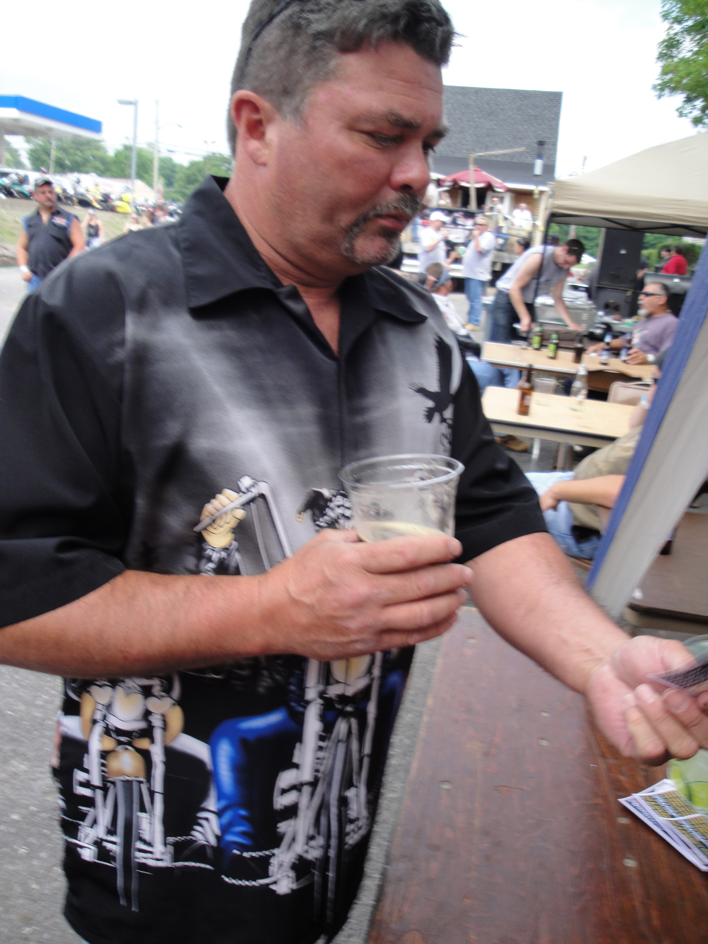 Higie's Iron Horse Saloon Summer BBQ Series — man at the bar with event crowd behind him