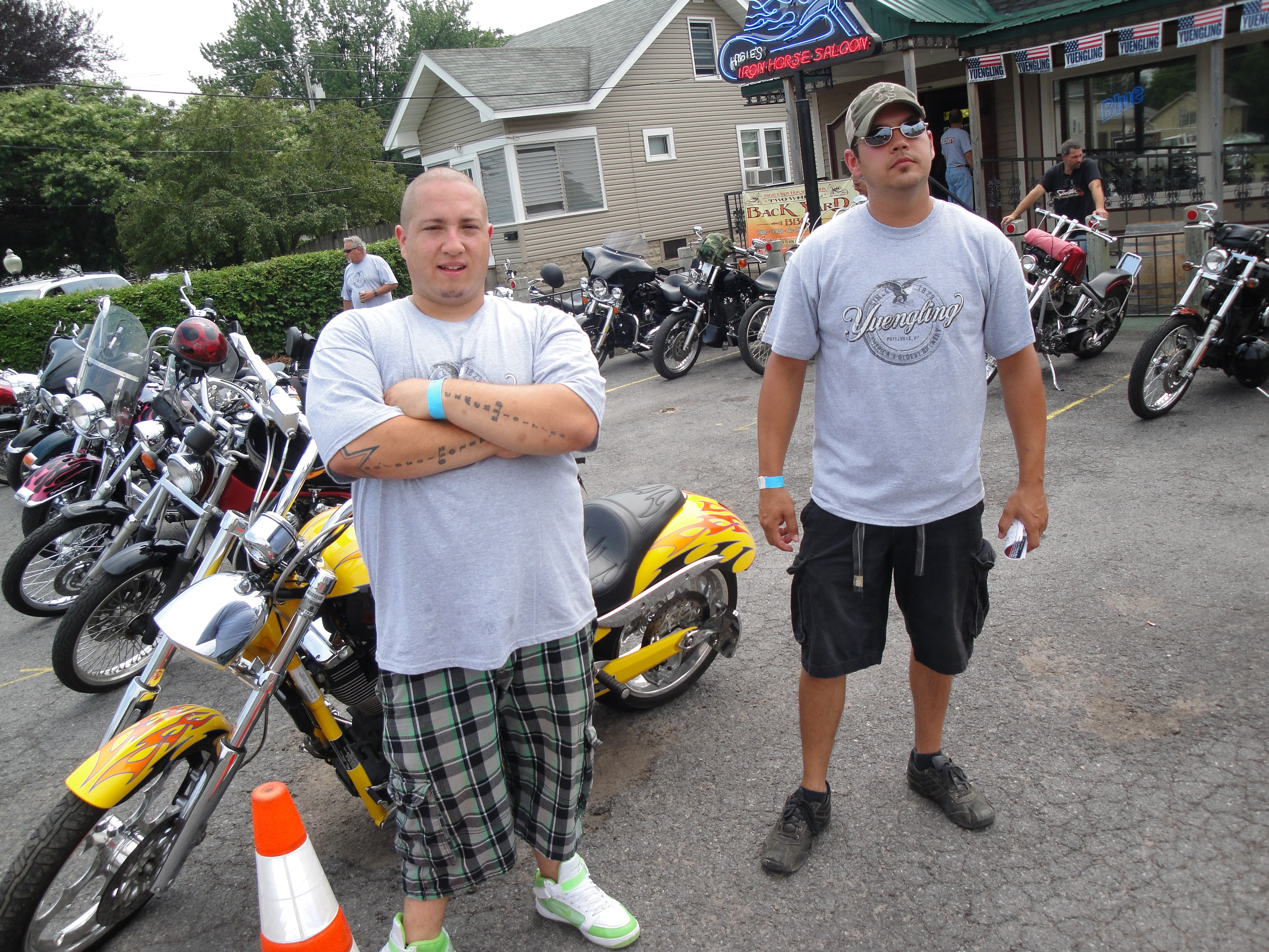 Higie's Iron Horse Saloon Summer BBQ Series — two guys posing in front of yellow flame chopper