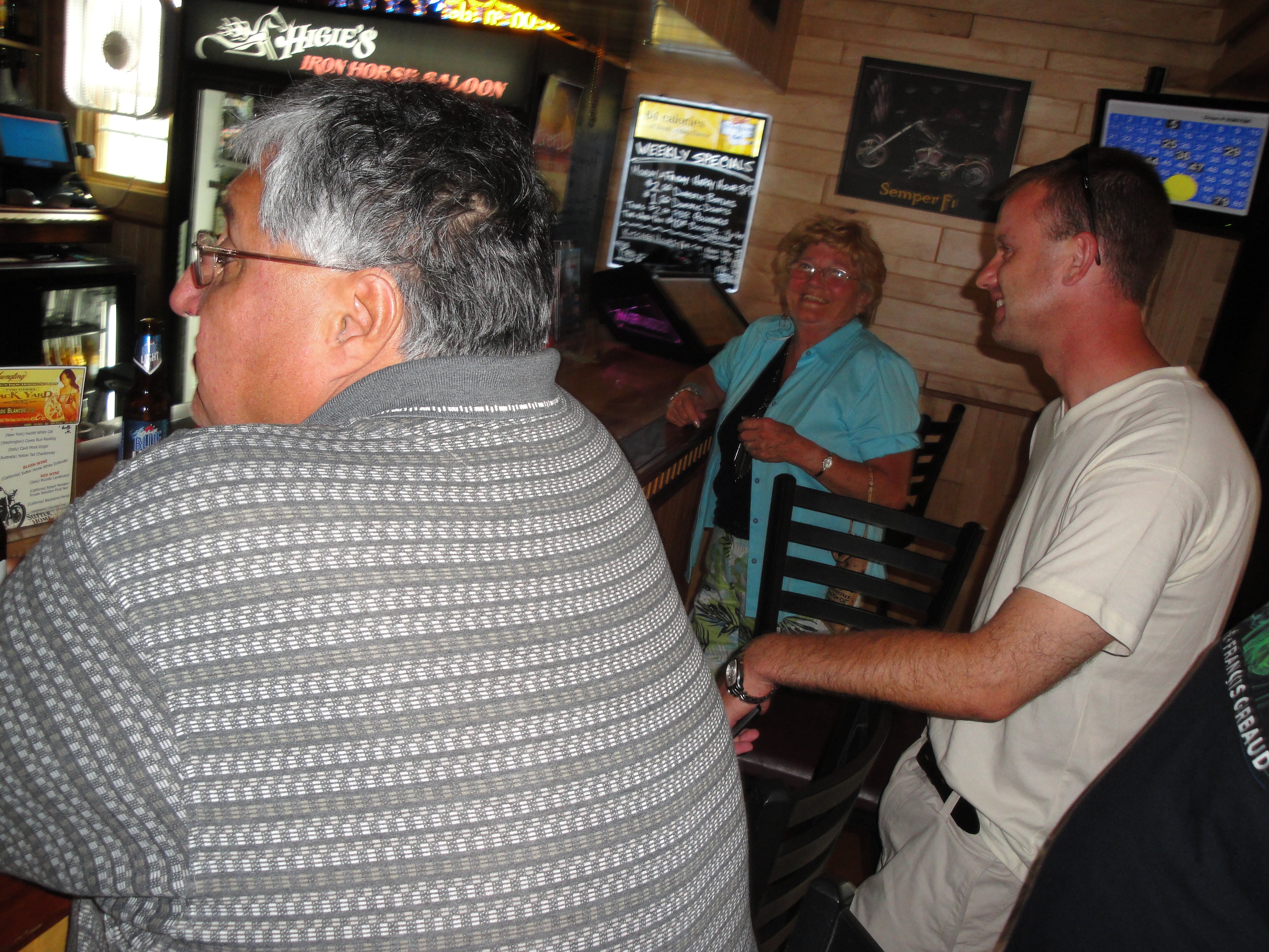 Higie's Iron Horse Saloon Summer BBQ Series — older couple chatting inside the saloon