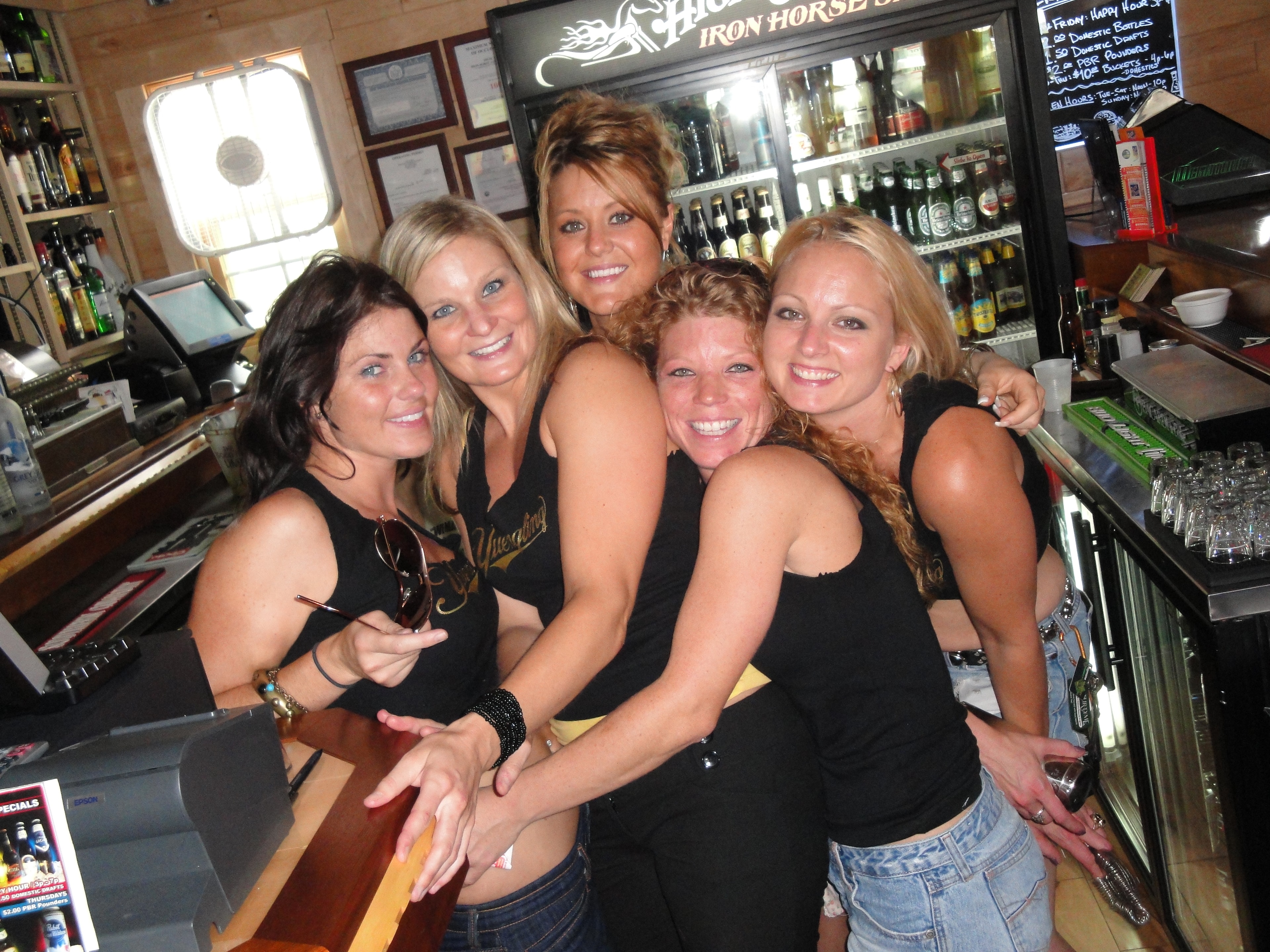 Higie's Iron Horse Saloon Summer BBQ Series — five women posing behind the bar