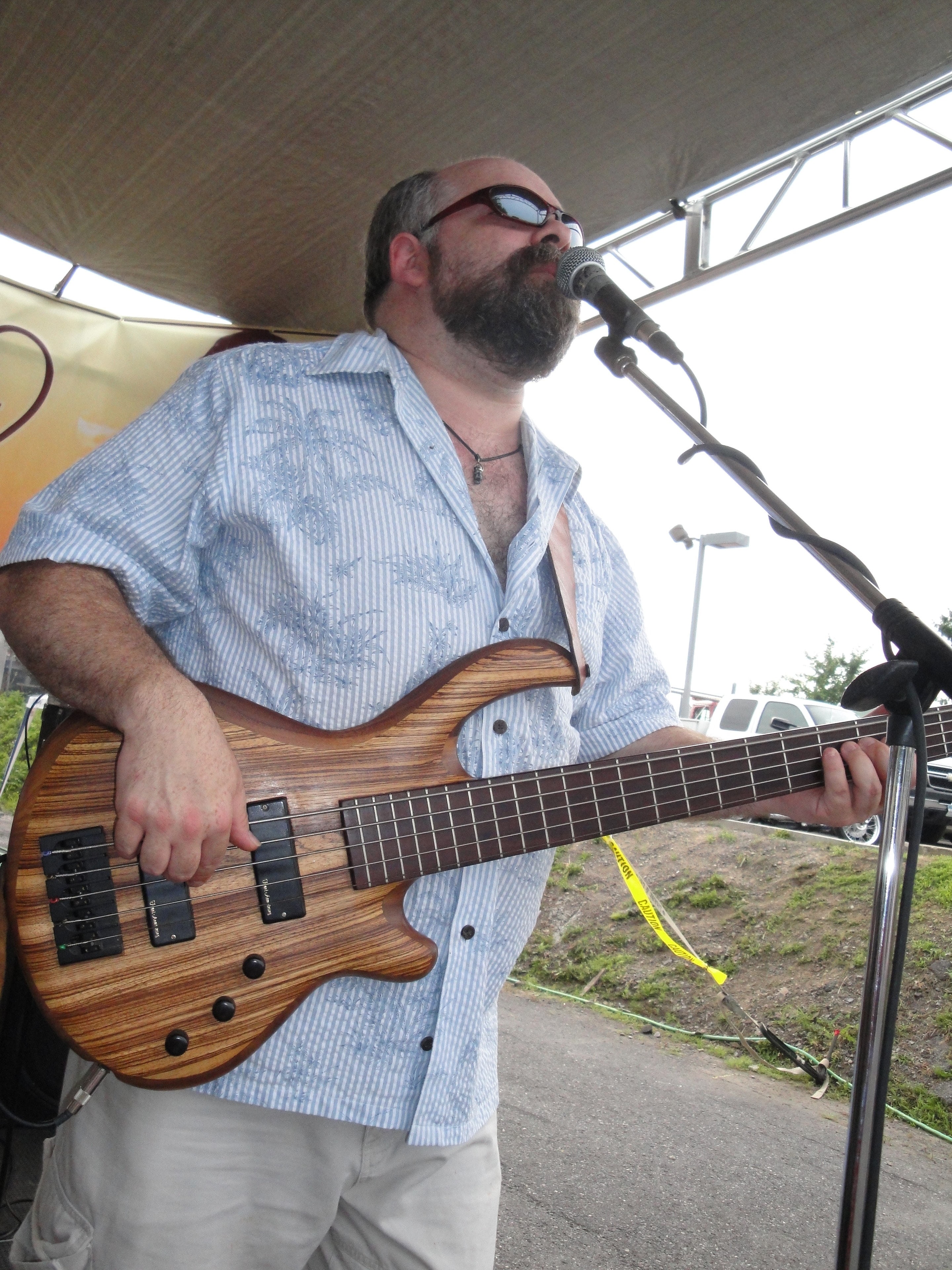 Higie's Iron Horse Saloon Summer BBQ Series — bass guitarist performing on outdoor stage