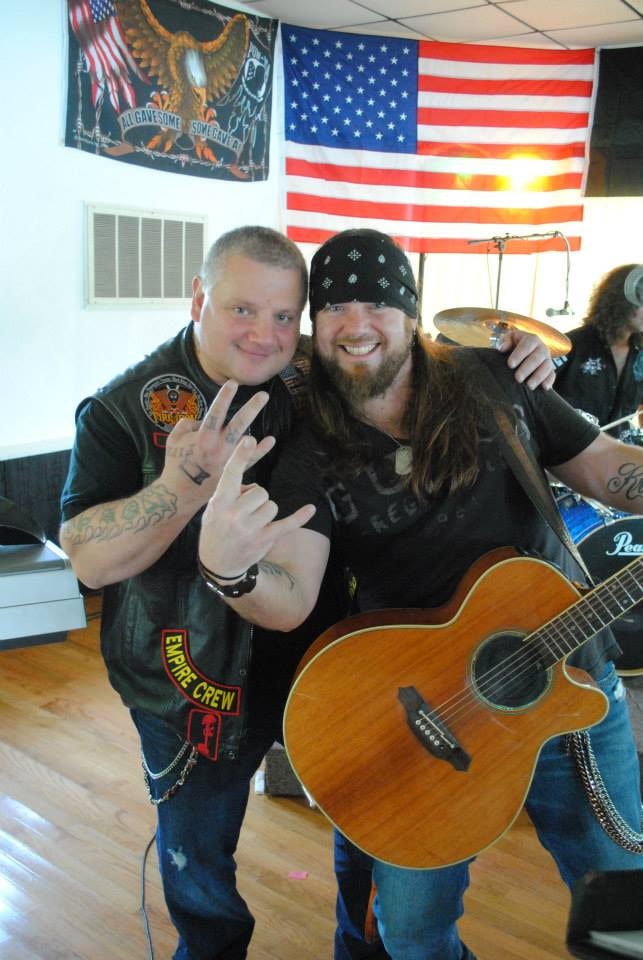 Pearl Street Jam Kick-Start Party — guitarist with attendee under American flag