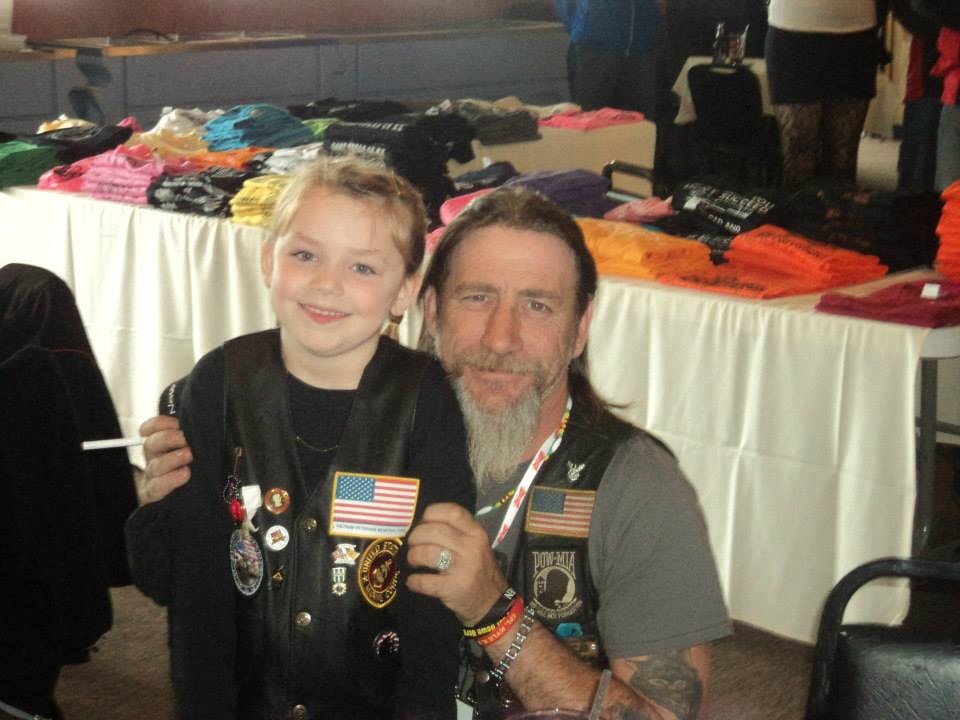 Pearl Street Jam Kick-Start Party — young girl and veteran at merchandise table