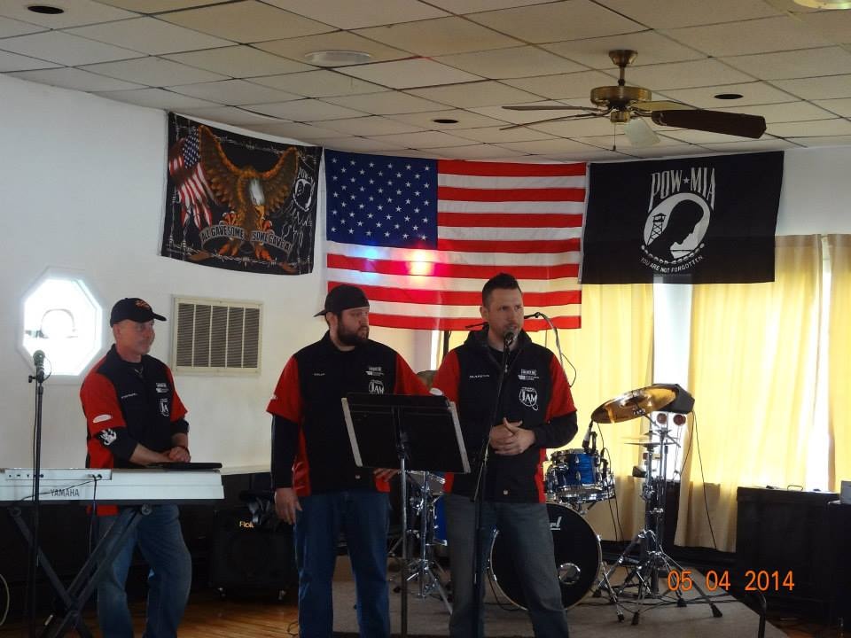 Pearl Street Jam Kick-Start Party — band performing on stage with flags
