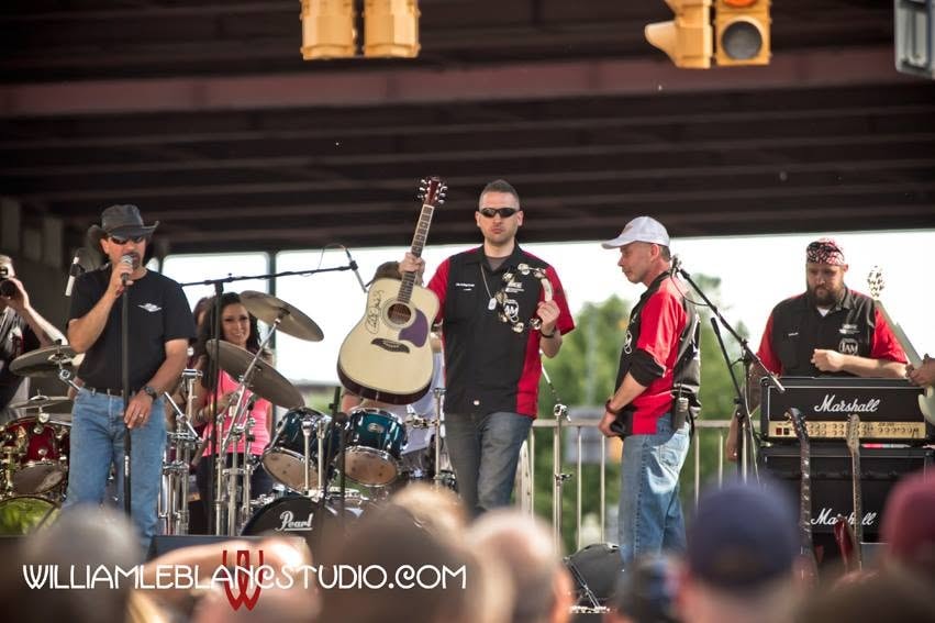 Pearl Street Jam — band performing on stage at outdoor event