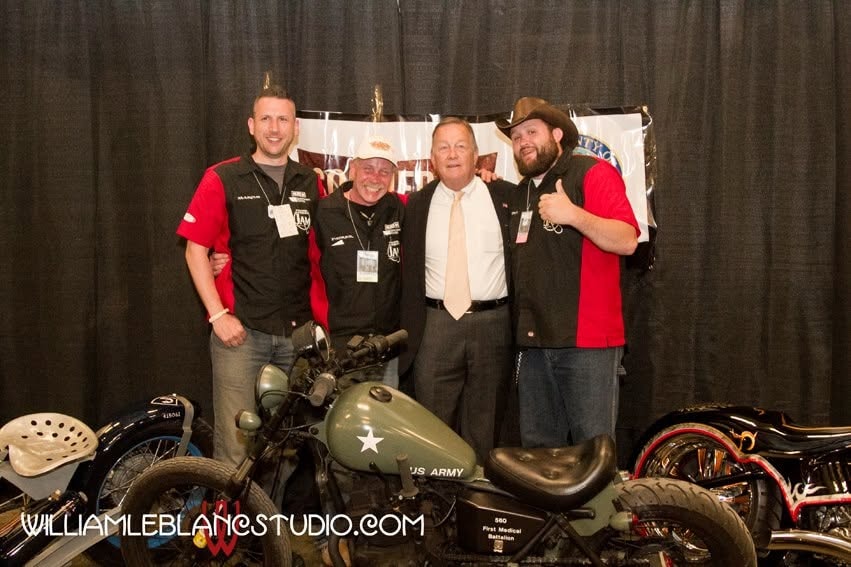 Pearl Street Jam — crew posing with US Army motorcycle indoors