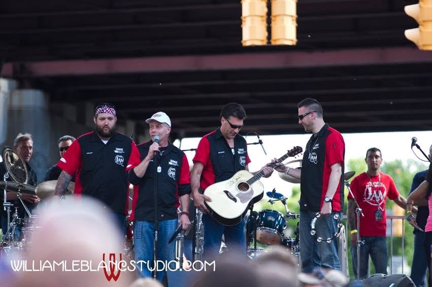 Pearl Street Jam — crew on stage presenting signed acoustic guitar